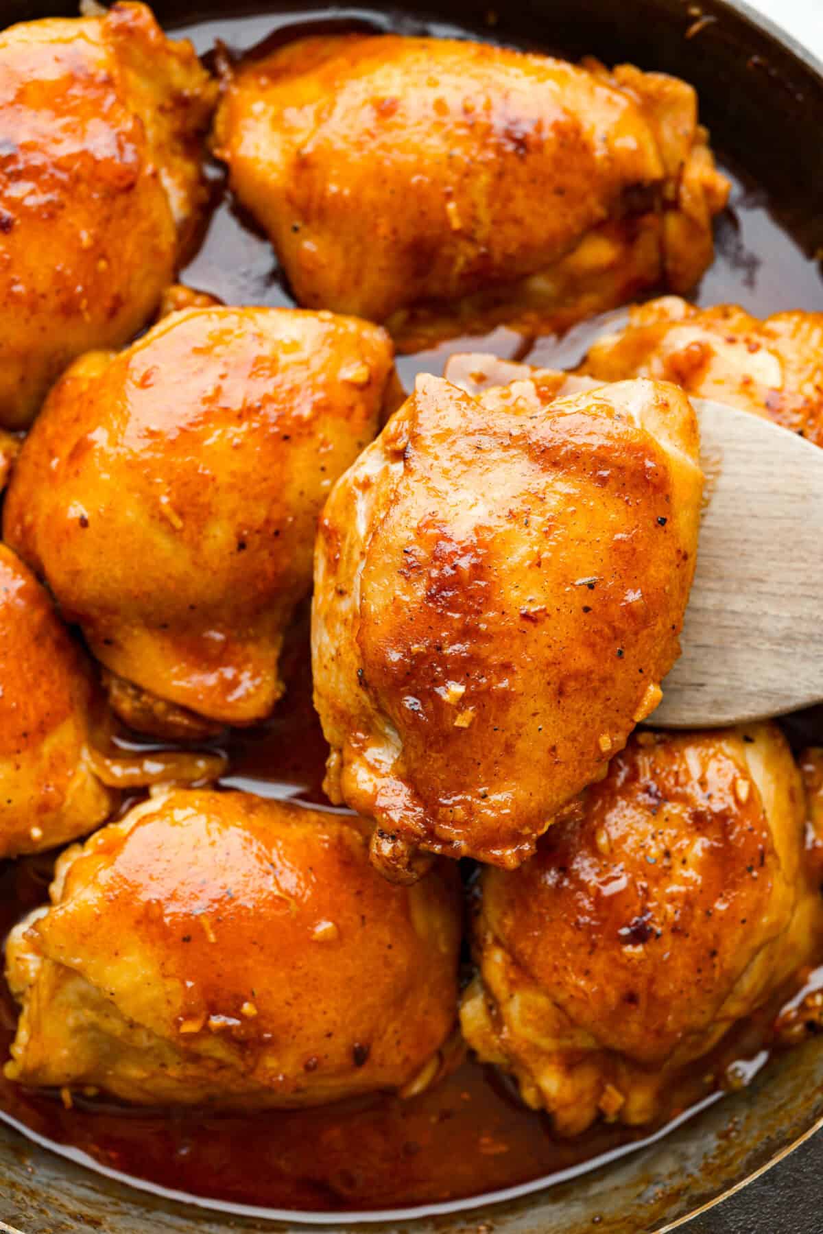 If you want a thicker sauce remove ยผ cup of the sauce, and whisk 1 teaspoon of cornstarch into it. Pour the mixture into the pan with the chicken and stir to incorporate, cook until it thickens. Close up shot of coca-cola chicken thighs in a skillet.