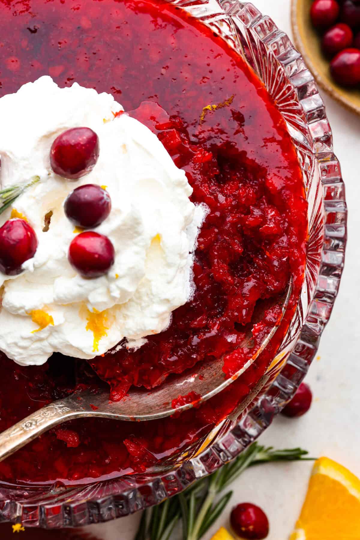 Cranberry Jello Salad is the best combination of tart, tangy, and sweet! It's similar to cranberry sauce but a little sweeter from the jello with undertones of orange and pineapple. Add it to your holiday spread and watch it disappear! Close up shot of the cranberry jello salad.