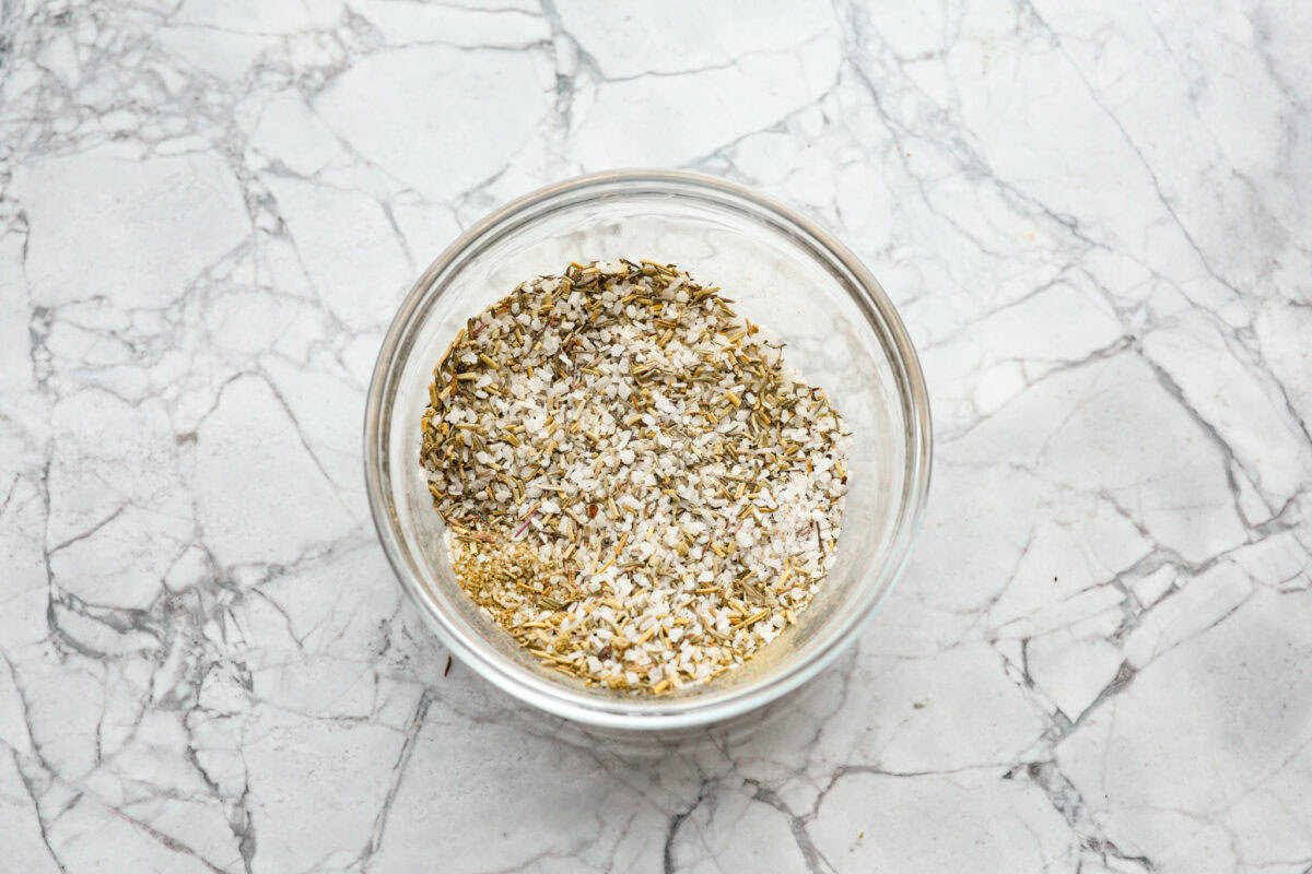 When you dry brine your turkey, you end up with a beautifully browned bird with crispy skin on the outside and juicy, flavorful meat on the inside! It will for sure be one of the most flavorful, moist turkeys you've ever had! Overhead shot of salt and seasonings mixed together in a bowl.