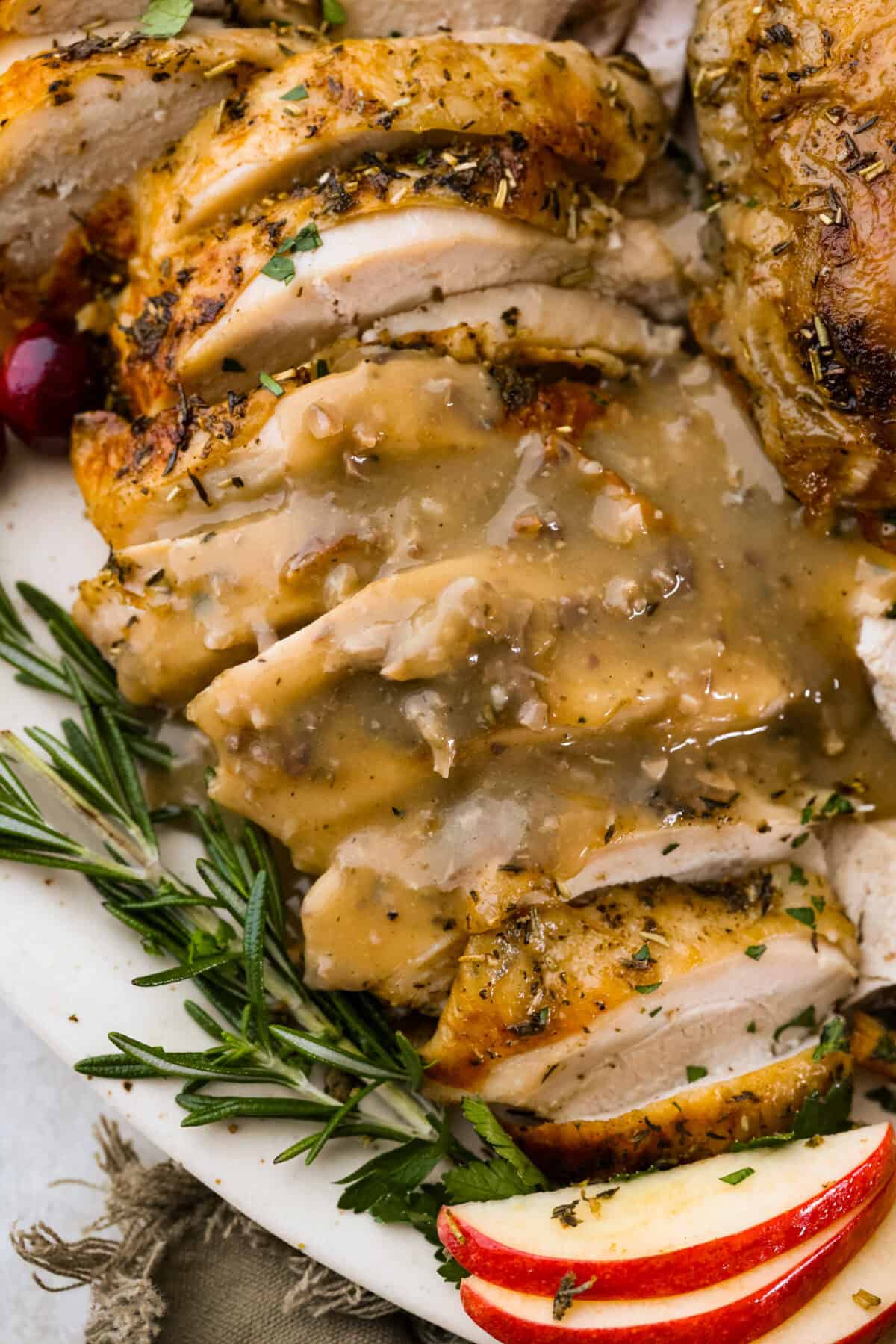 Giblet gravy is a labor of love, but the flavor is unmatched! Using the turkey's neck, gizzard, heart, liver, and drippings, you can make the best gravy you've ever had! It will be the perfect complement to your holiday turkey dinner. Overhead shot of plated turkey with giblet gravy poured over the top.