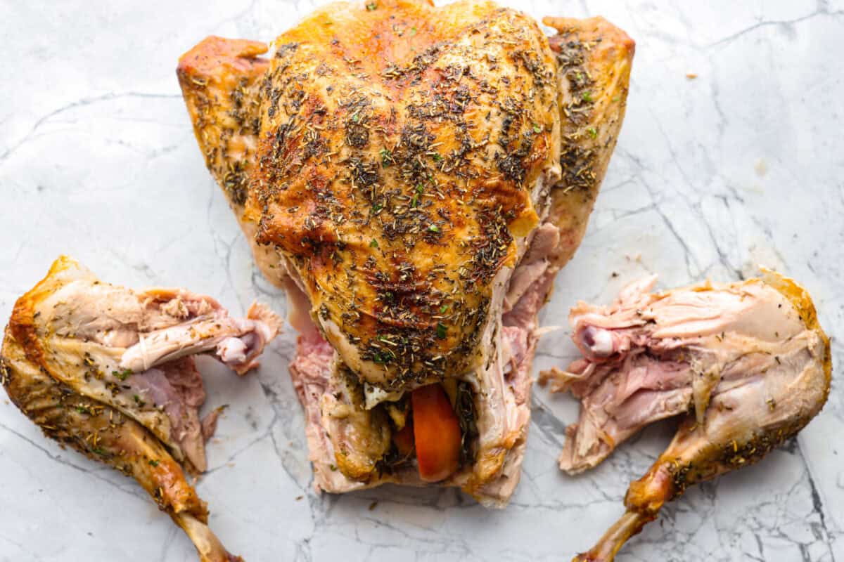 Learning how to carve a turkey is easier than you think! My step-by-step tutorial is here to help you along the way. Impress your guests with your beautifully carved turkey. Second photo of both turkey legs removed from the turkey.