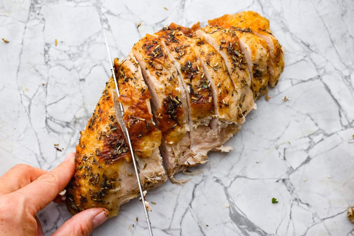 Learning how to carve a turkey is easier than you think! My step-by-step tutorial is here to help you along the way. Impress your guests with your beautifully carved turkey. Sixth photo of the breast being sliced.