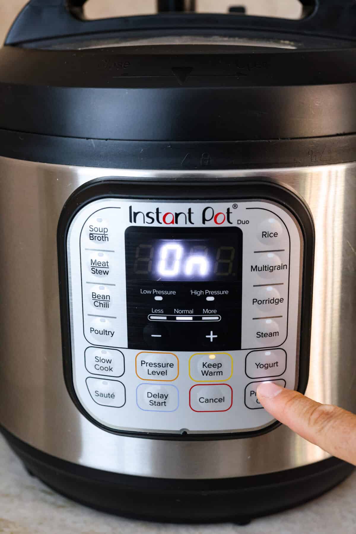 STOP being scared of your Instant Pot! This beginner's guide on How to Use an Instant Pot will help you feel comfortable and confident when using this magical kitchen appliance. It makes cooking fast, easy, and convenient. First photo of turning on the Instant Pot.