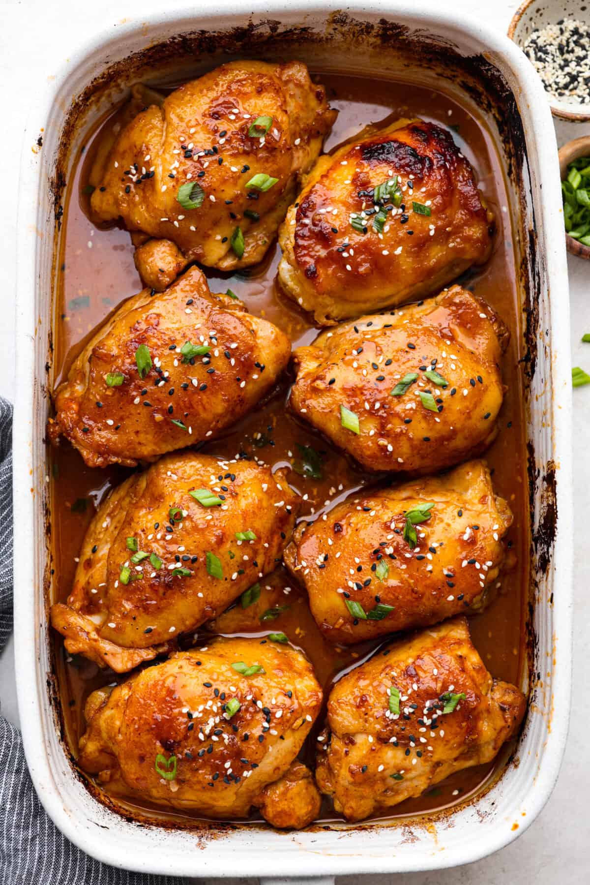 Miso chicken is super delicious and perfect for fans of bold Asian flavor. The skin crisps up, the meat stays juicy and tender, and the glaze caramelizes, creating a savory sauce perfect for drizzling over rice. Overhead shot of miso chicken cooked in a baking dish.