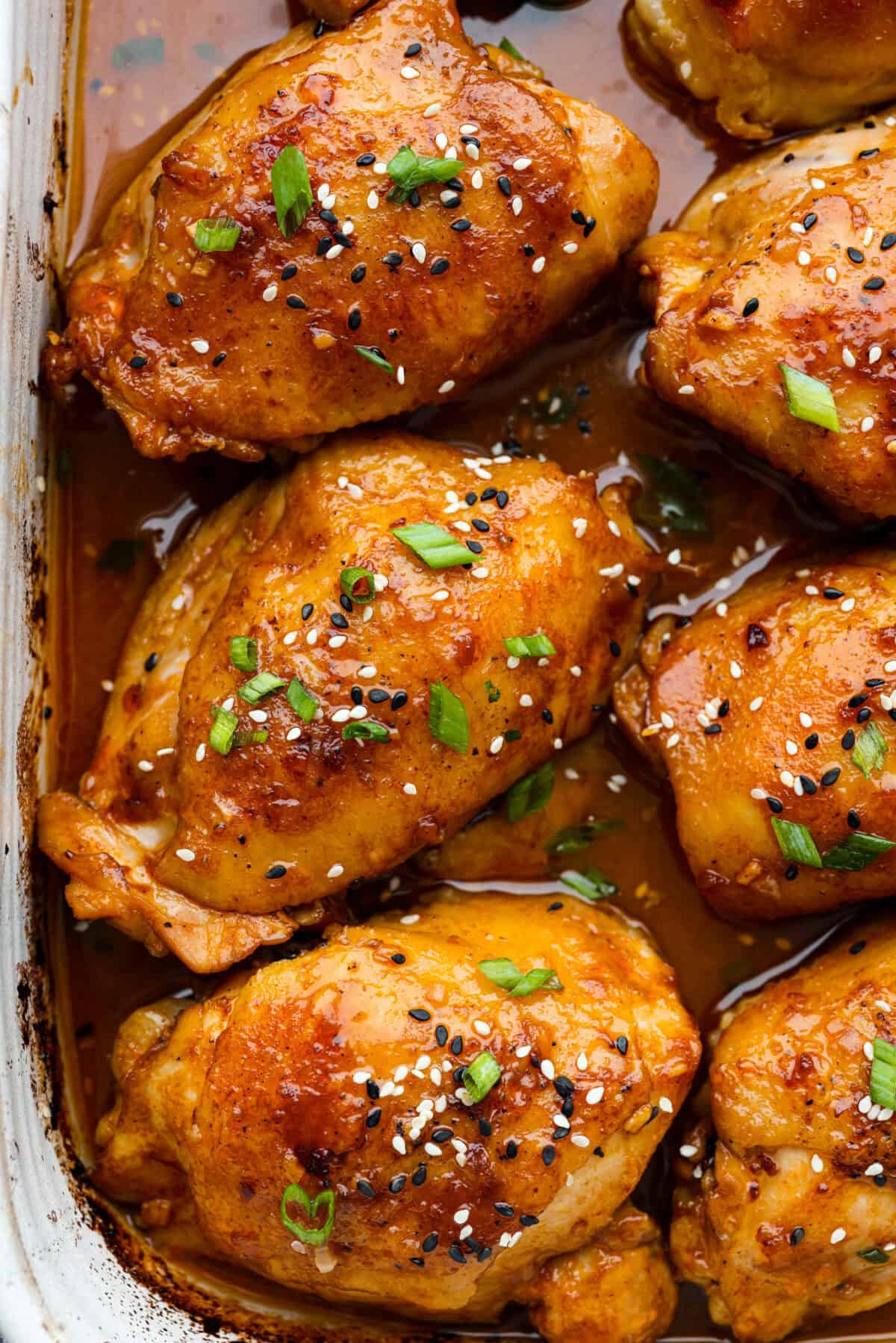 Miso chicken is super delicious and perfect for fans of bold Asian flavor. The skin crisps up, the meat stays juicy and tender, and the glaze caramelizes, creating a savory sauce perfect for drizzling over rice. Close up shot of baked miso chicken.