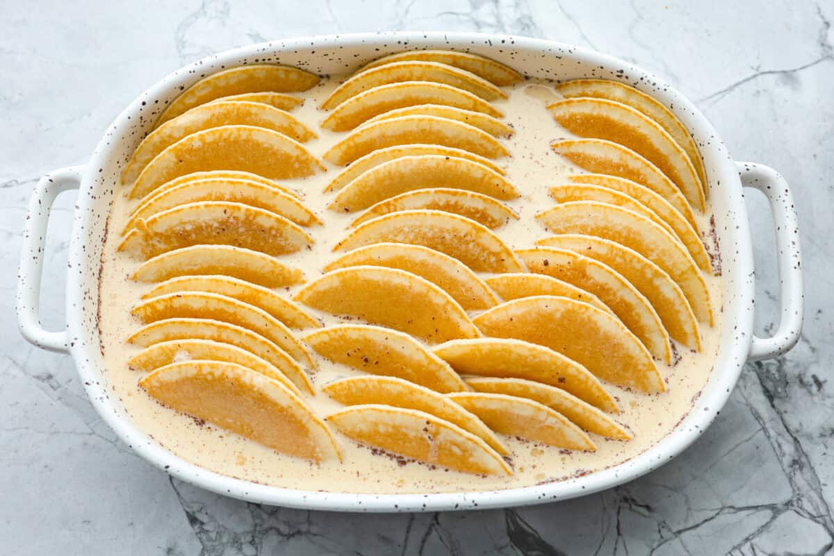 Pancake Casserole is a fun new Christmas or Easter breakfast idea. It has lots of buttery pancakes soaked overnight in a creamy custard, is baked to perfection, and served with your favorite toppings! Overhead shot of the completed dish before being baked.