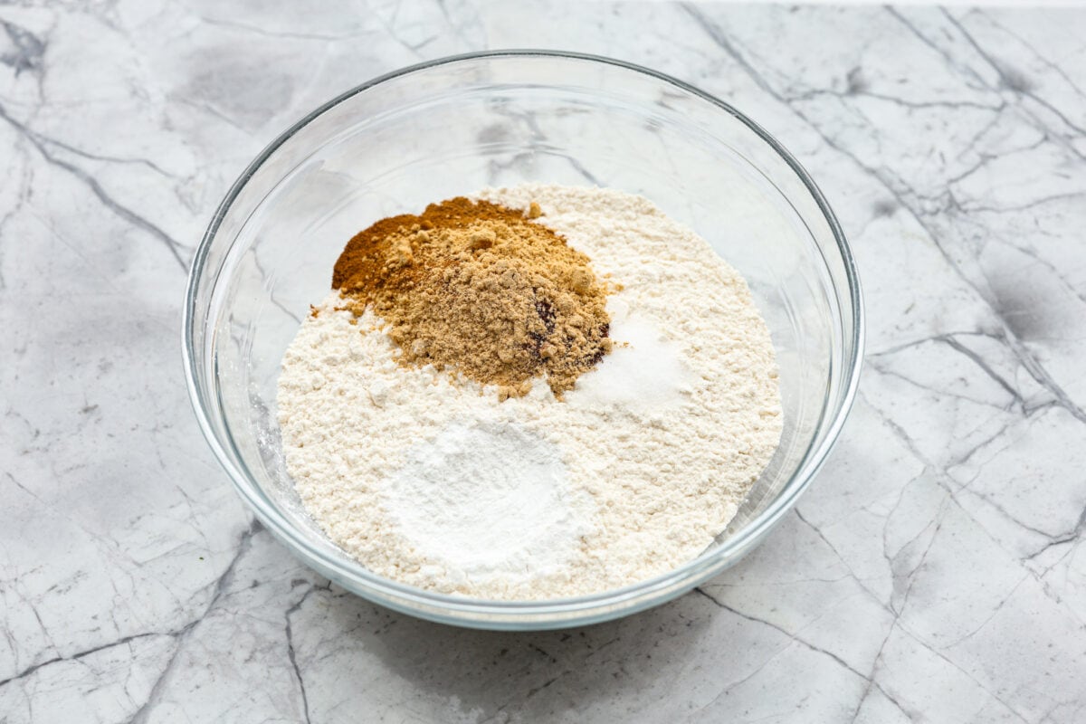 Starbucks copycat gingerbread loaf is the ultimate holiday treat! It's coated in a simple cream cheese frosting and is full of warm spices and rich molasses flavor. Enjoy it for Christmas brunch or a sweet treat at night! Overhead shot of a bowl of dry ingredients.