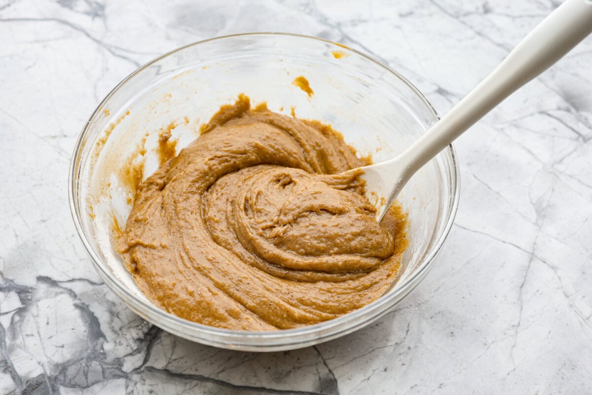Starbucks copycat gingerbread loaf is the ultimate holiday treat! It's coated in a simple cream cheese frosting and is full of warm spices and rich molasses flavor. Enjoy it for Christmas brunch or a sweet treat at night! Overhead shot of bread batter mixed together in a mixing bowl.