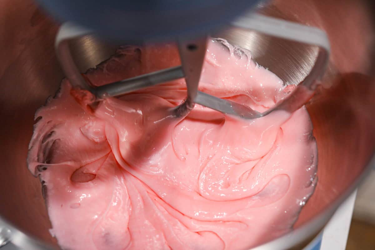 Homemade cherry cordials are a tasty, nostalgic treat! They're made with sweet cherries that are coated in a rich chocolate shell. Make them for Christmas or Valentineโs Day, and watch them disappear! Close up shot of fondant being mixed in a stand mixer.