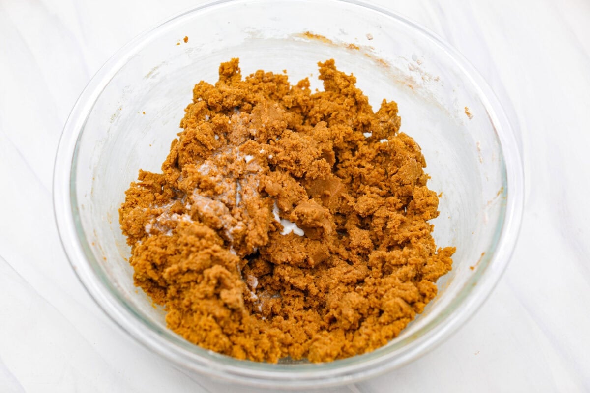 These gingerbread crinkle cookies are incredibly soft and flavorful! Their deep molasses flavor, spiced to perfection and rolled in powdered sugar, is so good with a glass of milk. They are the perfect cookies to make for Santa this holiday season. Overhead shot of wet and dry ingredients mixed together.