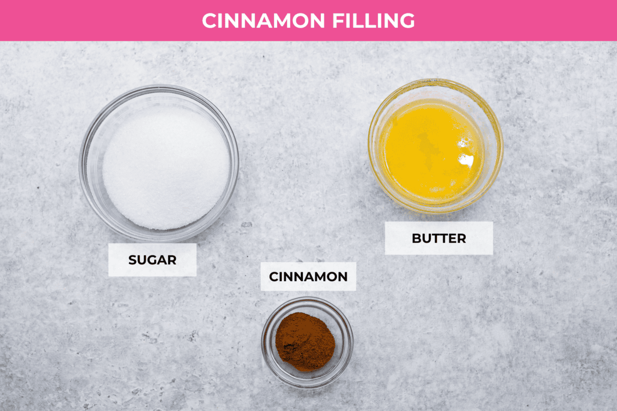 Biscuit Cinnamon Rolls are the most amazing twist on a classic! They are perfectly light, fluffy, and packed with cinnamon. The texture is more flakey and moist than traditional cinnamon rolls! Whether it’s for a cozy weekend breakfast or a holiday brunch, these hit the spot! Overhead shot of labeled cinnamon filing ingredients.