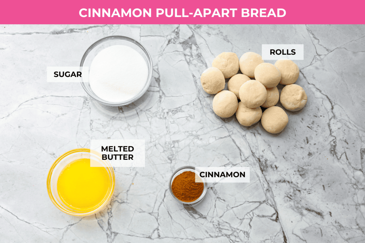 Irresistible Cinnamon Pull-Apart Bread is inspired by the popular cinnamon bread served at the Grist Mill eatery in Dollywood. With this copycat version, you can recreate that buttery, sweet deliciousness easily with frozen rolls. Overhead shot of labeled bread ingredients.