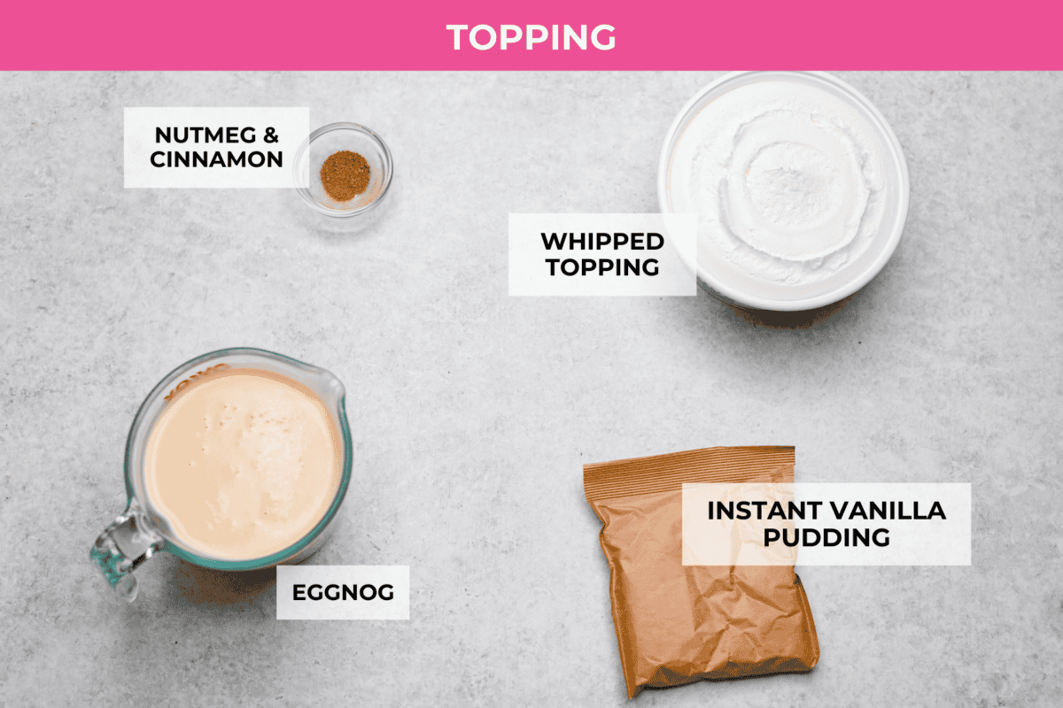 Eggnog Poke Cake could not be more perfect for the holiday season! It combines the rich flavor of eggnog with the soft, moist texture of a classic poke cake. Add fluffy whipped topping and a sprinkle of nutmeg and cinnamon to really wow your family! Overhead shot of labeled topping ingredients.