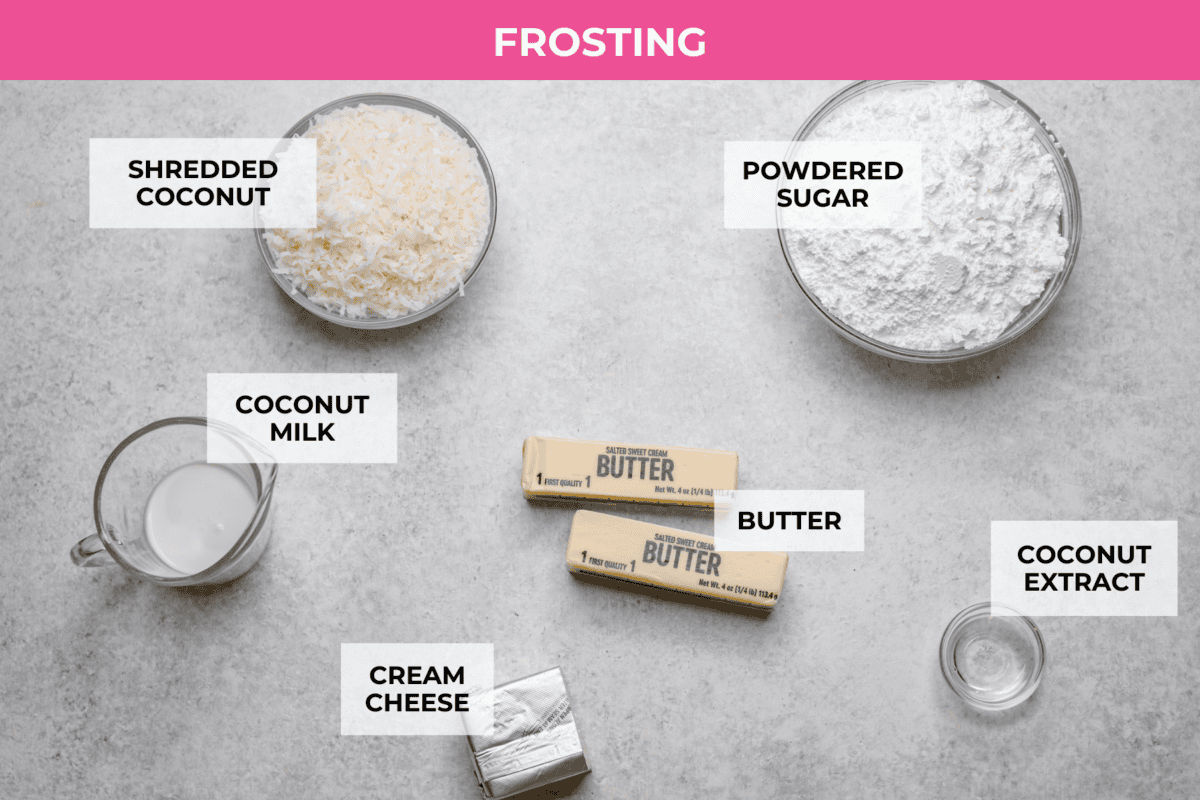 Tom Cruise coconut cake is a dense pound cake with coconut flavor and silky white chocolate throughout. The indulgent frosting is a coconut cream cheese buttercream with sweetened coconut on the outside. It's a coconut lover's dream—but a super sweet one. Overhead shot of labeled frosting ingredients.