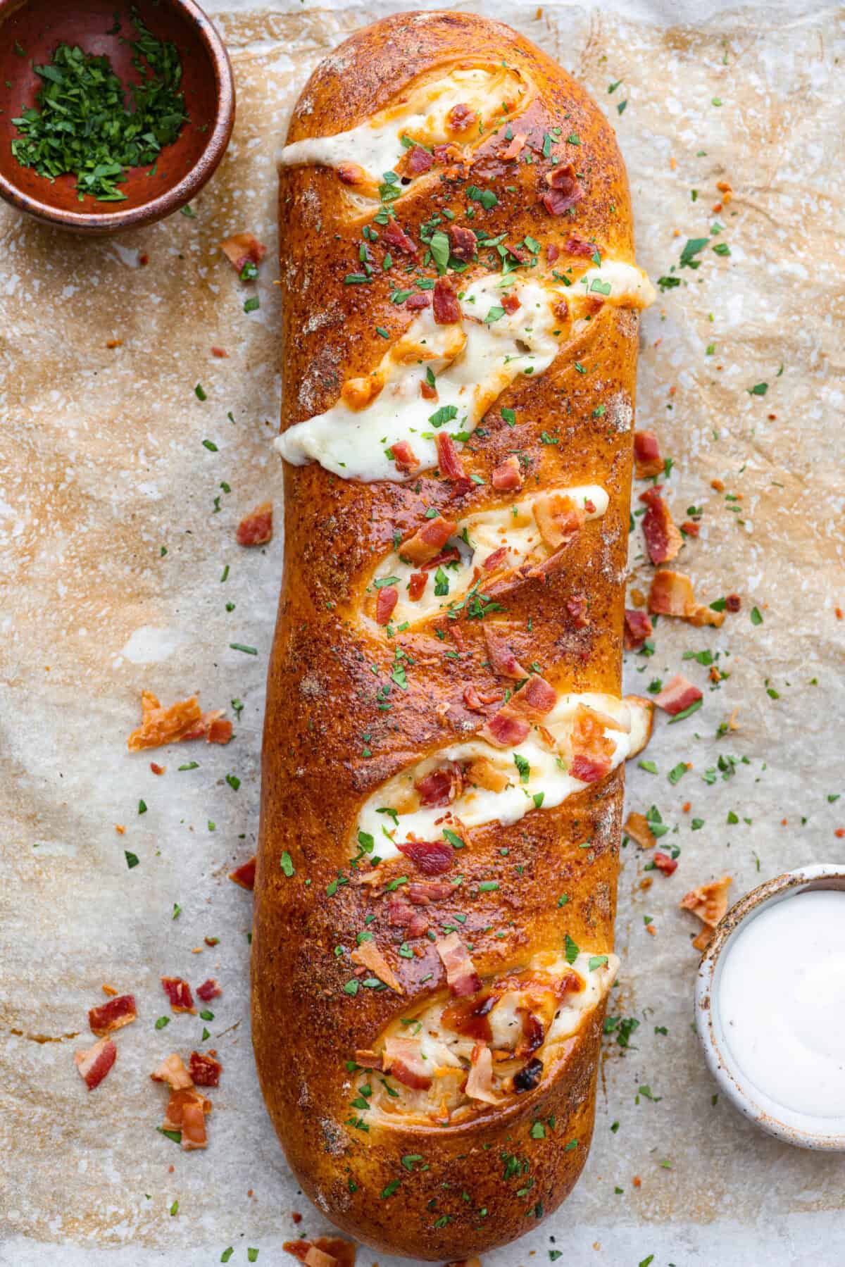 This Chicken Bacon Ranch Stromboli combines the tasty trio of tender chicken, crispy bacon, and creamy ranch dressing, all wrapped in golden pizza dough. It’s quick to prep and packed with flavor. Overhead shot of baked chicken bacon ranch Stromboli.