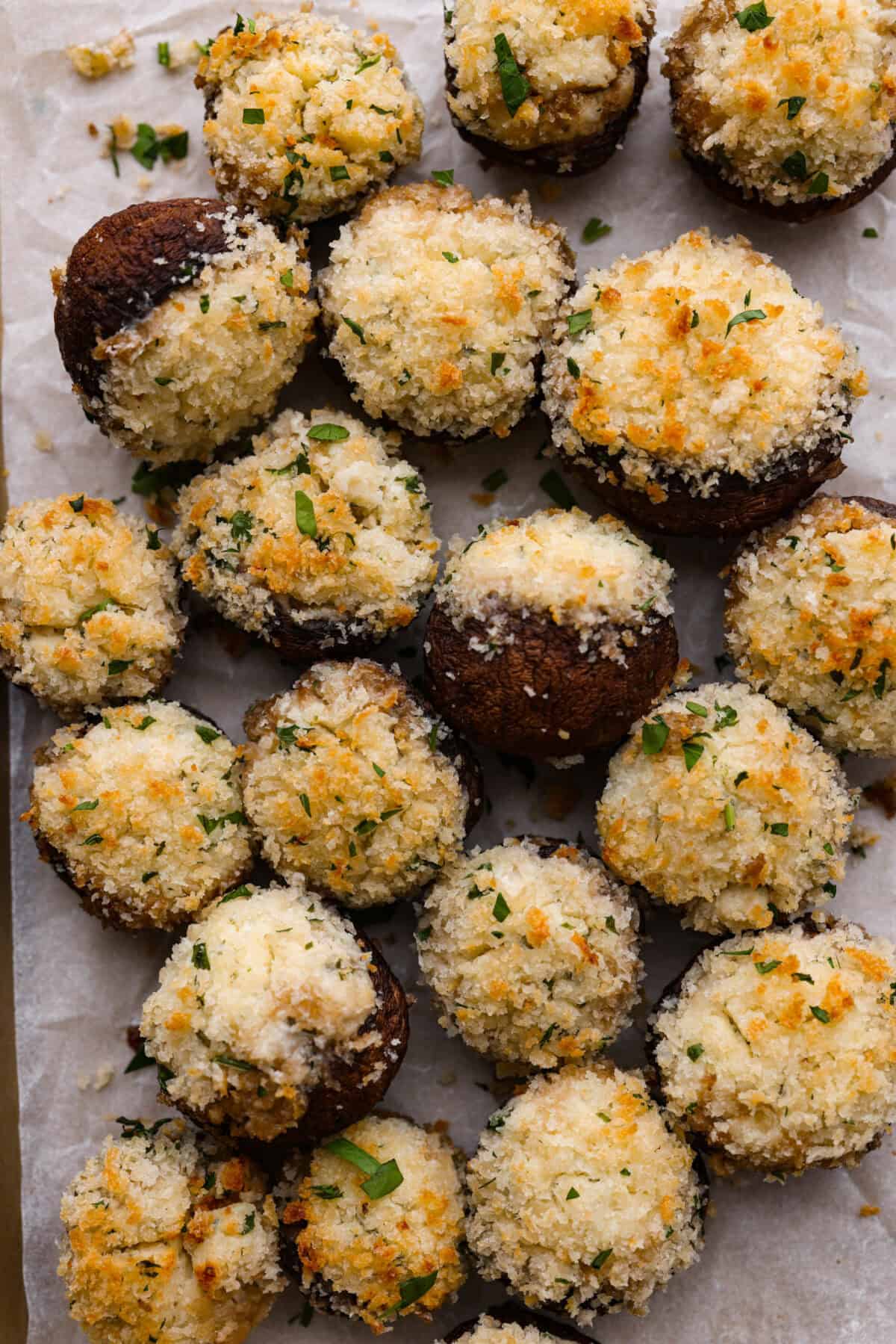 Boursin stuffed mushrooms are a fun, delicious appetizer or side dish. These creamy, cheesy stuffed mushrooms are packed with flavorful Boursin cheese and topped with a delightful breadcrumb crunch. Overhead shot of Boursin Stuffed mushrooms.