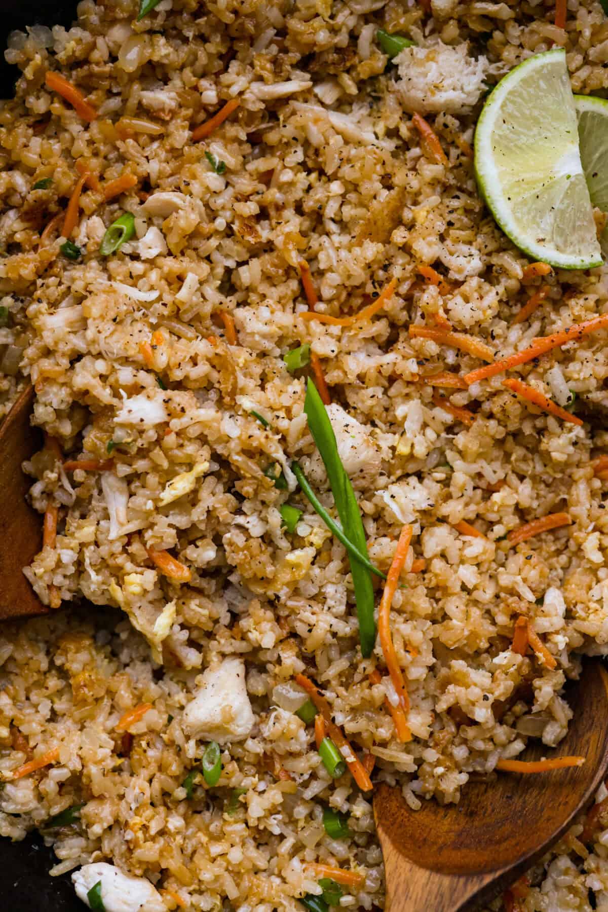 Delicious crab fried rice comes together in just 25 minutes with simple ingredients and tons of flavor! It combines the sweetness of lump crab meat with the savory flavors of classic fried rice for an endlessly satisfying dish that's sure to become a family favorite! Close up shot of crab fried rice.