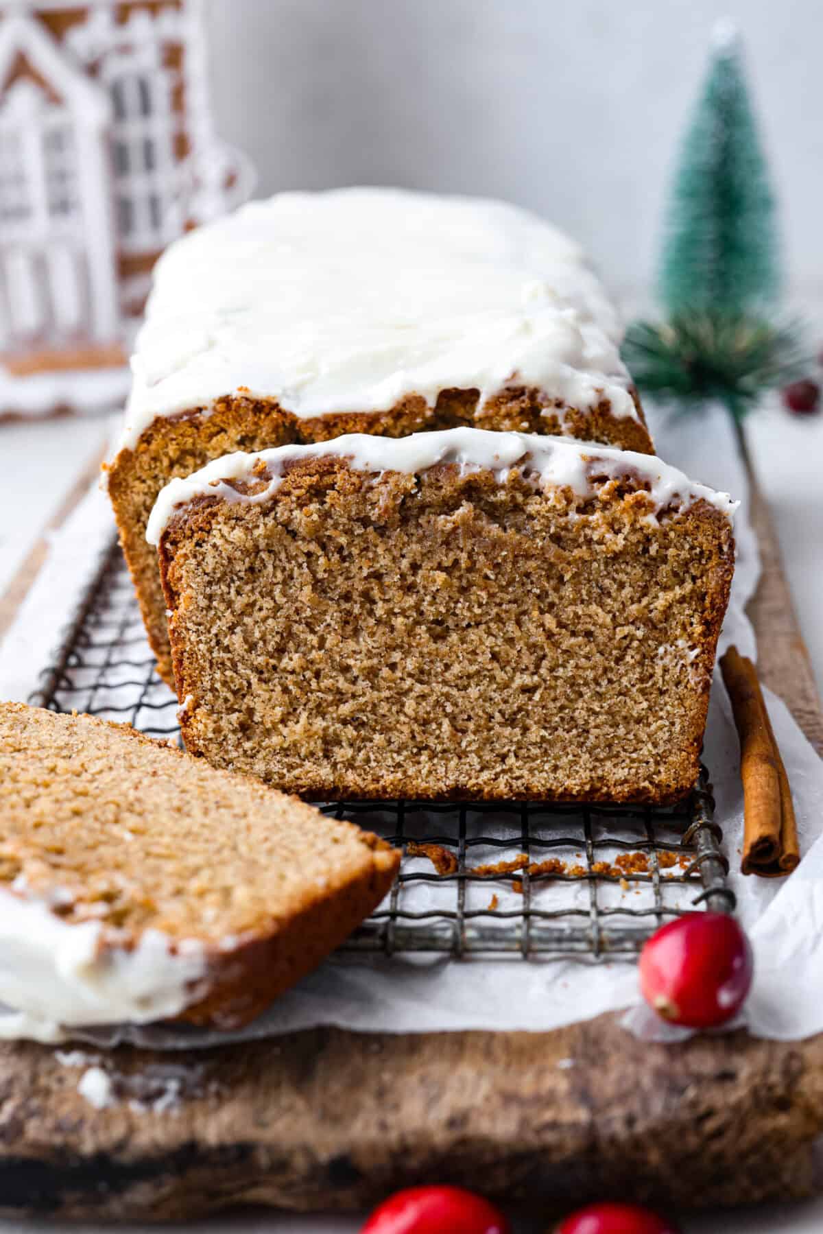 Starbucks copycat gingerbread loaf is the ultimate holiday treat! It's coated in a simple cream cheese frosting and is full of warm spices and rich molasses flavor. Enjoy it for Christmas brunch or a sweet treat at night! Side shot of a gingerbread loaf with slices taken out.