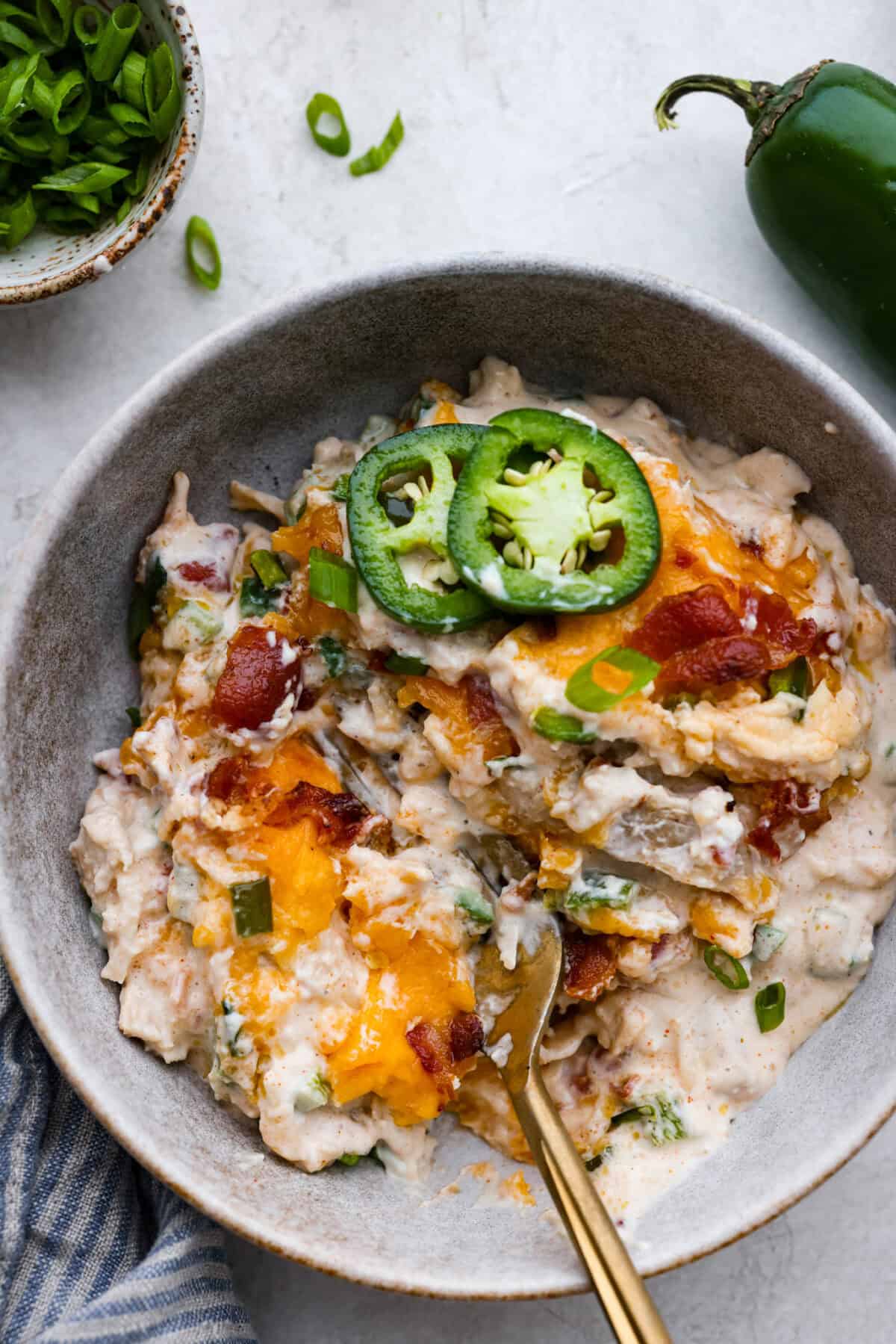 Spice up dinnertime with this creamy Jalapeño Popper Casserole! Packed with tender chicken, melty cheese, and just the right kick of heat, it's hearty and so easy to make. Delicious comfort food with a spicy twist! Overhead shot of plated jalapeño popper casserole.