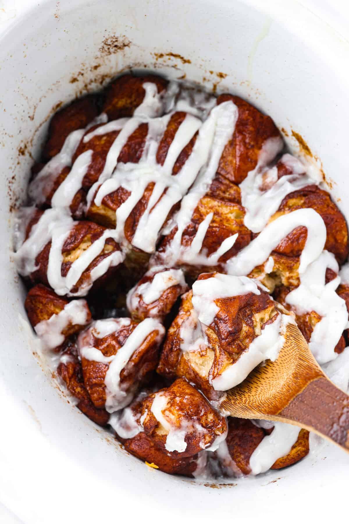 Crockpot monkey bread is an easy, gooey treat made in your slow cooker. It’s packed with soft biscuit pieces, cinnamon-sugar flavor, and a sweet buttery glaze. No oven needed! Overhead shot of crockpot monkey bread in the crock pot.