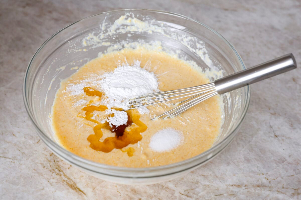 Spoon bread is a beloved classic Southern side dish. It’s similar to cornbread but is less sweet and has a softer, almost soufflé-like texture. This unique bread is best enjoyed warm with a dollop of butter, a drizzle of honey or served alongside a hearty bowl of chili. Angle shot of the cornmeal and milk mixture with honey, egg yolks, baking powder and salt.
