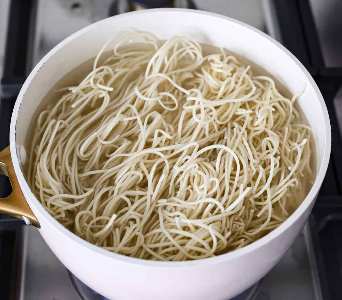 Add outbound links by finding items you can link through Target links. And add them the same way you would add an internal link by pasting the link into the bar. Overhead shot of low mein noodles cooking in a pot of water.