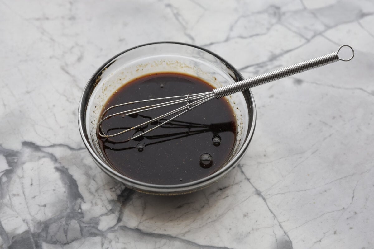 This A-1 copycat homemade steak sauce recipe is slightly sweet with a delicious tang from the vinegar. It's perfect for drizzling over your favorite cut of tender, juicy meat. Angle shot of ingredients whisked together in a bowl.