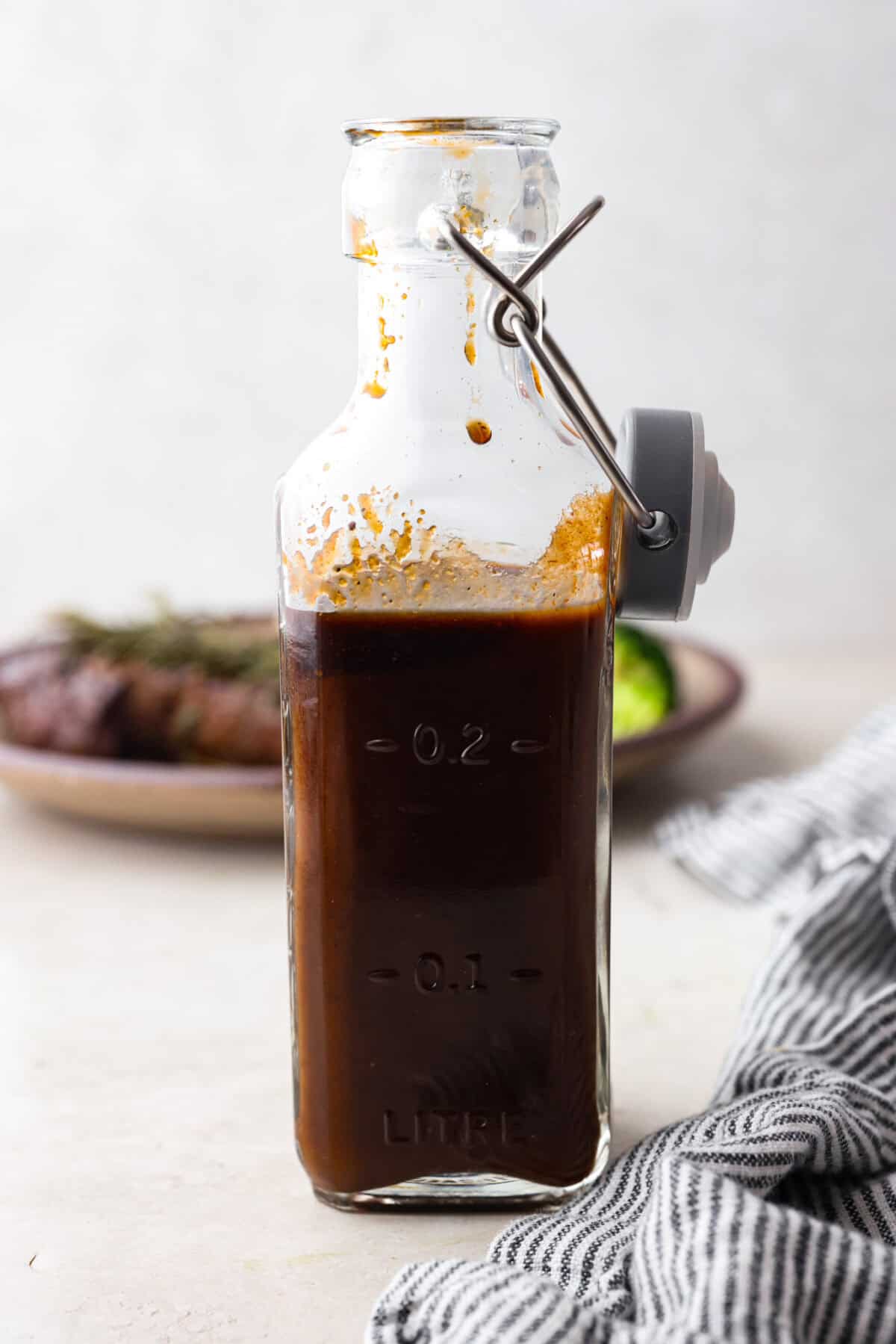 This A-1 copycat homemade steak sauce recipe is slightly sweet with a delicious tang from the vinegar. It's perfect for drizzling over your favorite cut of tender, juicy meat. Side shot of homemade steak sauce in a bottle.