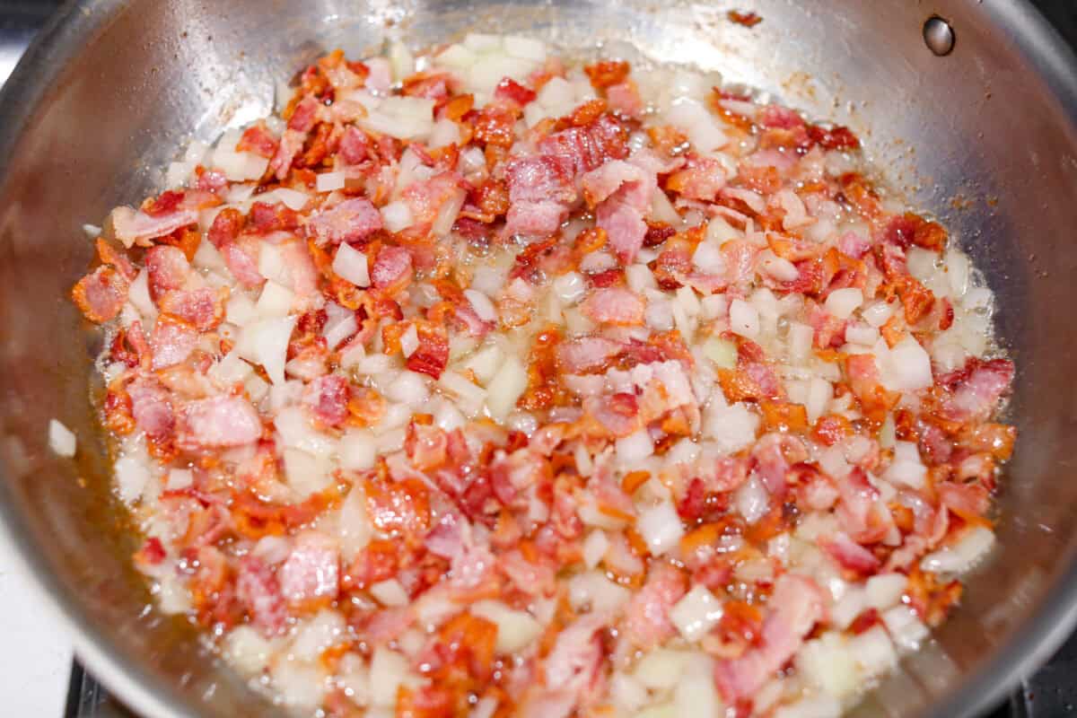 Kickstart your day with this hearty Amish Breakfast Casserole! It's loaded with crispy bacon, tender hash browns, and gooey melted cheese. This dish is a crowd-pleaser thatโs perfect for family breakfasts and holiday mornings! Overhead shot of bacon and onions cooking together in a skillet.