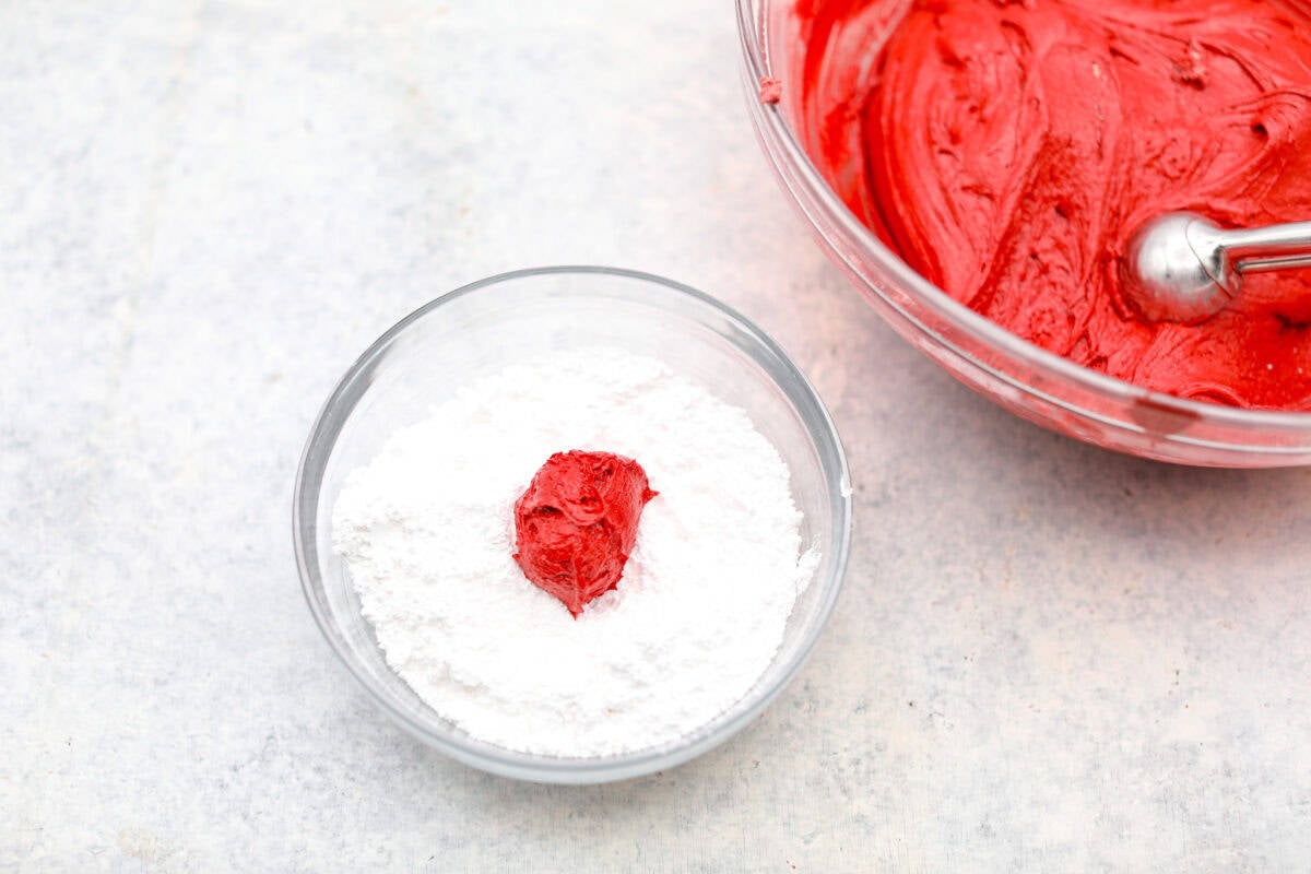 Gorgeous Cool Whip Cookies are made with just 4 simple ingredients! They bake up soft, fluffy, and bursting with flavor. Perfect for last-minute treats or when you’re craving something sweet without the fuss! Overhead shot of a scoop of dough in a bowl of powdered sugar.