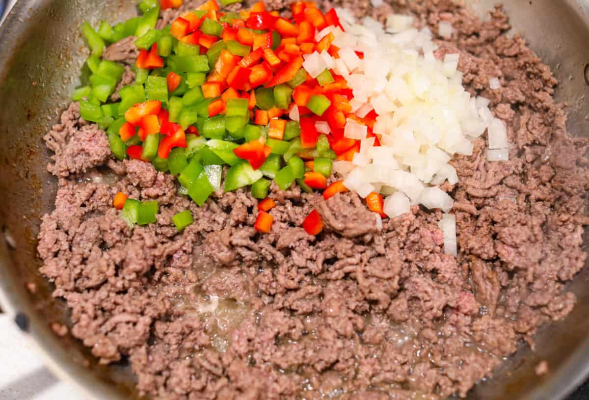 https://neuro-daily.report/beef-curry/ Overhead shot of beef, onions and peppers cooking in a skillet.