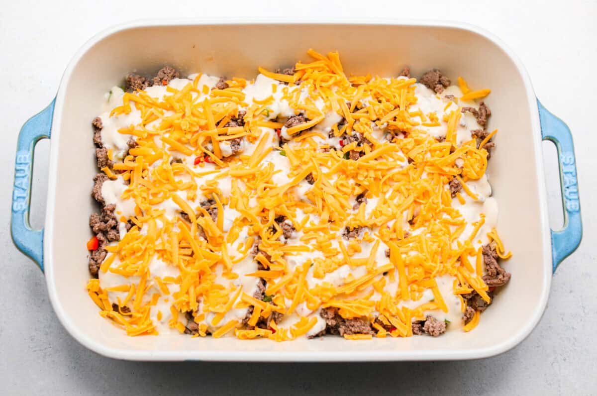 https://neuro-daily.report/beef-curry/ Overhead shot of cheese sprinkled over the top of the other ingredients.
