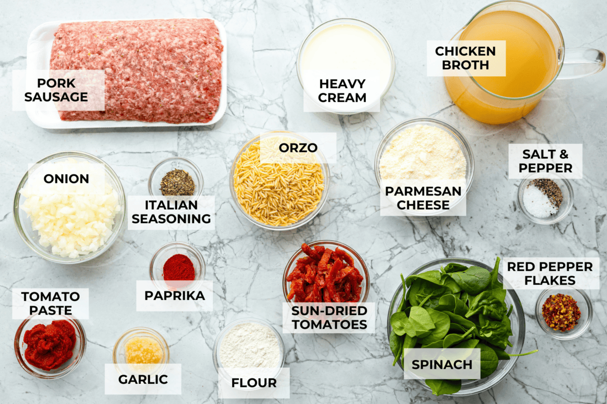 Warm up to this delicious Marry Me sausage orzo soup! It's hearty, super flavorful, and packed with seasoned sausage, tender orzo pasta, and plenty of bold, savory seasonings. Overhead shot of labeled ingredients.