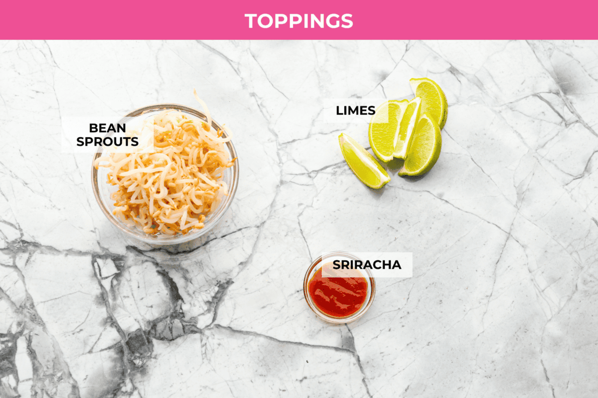 This simplified version of Vietnamese noodle soup brings the comforting flavors you love in Pho but with less effort. For a truly authentic experience, donโt miss out on this detailed recipe! Overhead shot of labeled topping ingredients.
