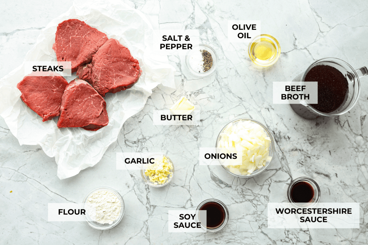 Craving Southern comfort food? This smothered steak is hearty, flavorful, and so satisfying. Perfectly cooked tender steak is covered in a rich, savory gravy that takes it to the next level. This steak is ready to enjoy in just 30 minutes! Overhead shot of labeled ingredients.