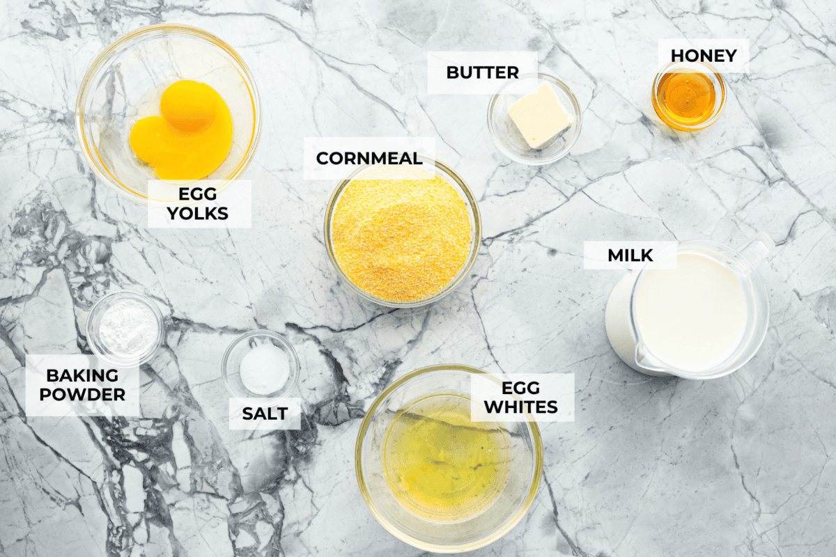 Spoon bread is a beloved classic Southern side dish. It’s similar to cornbread but is less sweet and has a softer, almost soufflé-like texture. This unique bread is best enjoyed warm with a dollop of butter, a drizzle of honey or served alongside a hearty bowl of chili. Overhead shot of labeled ingredients.