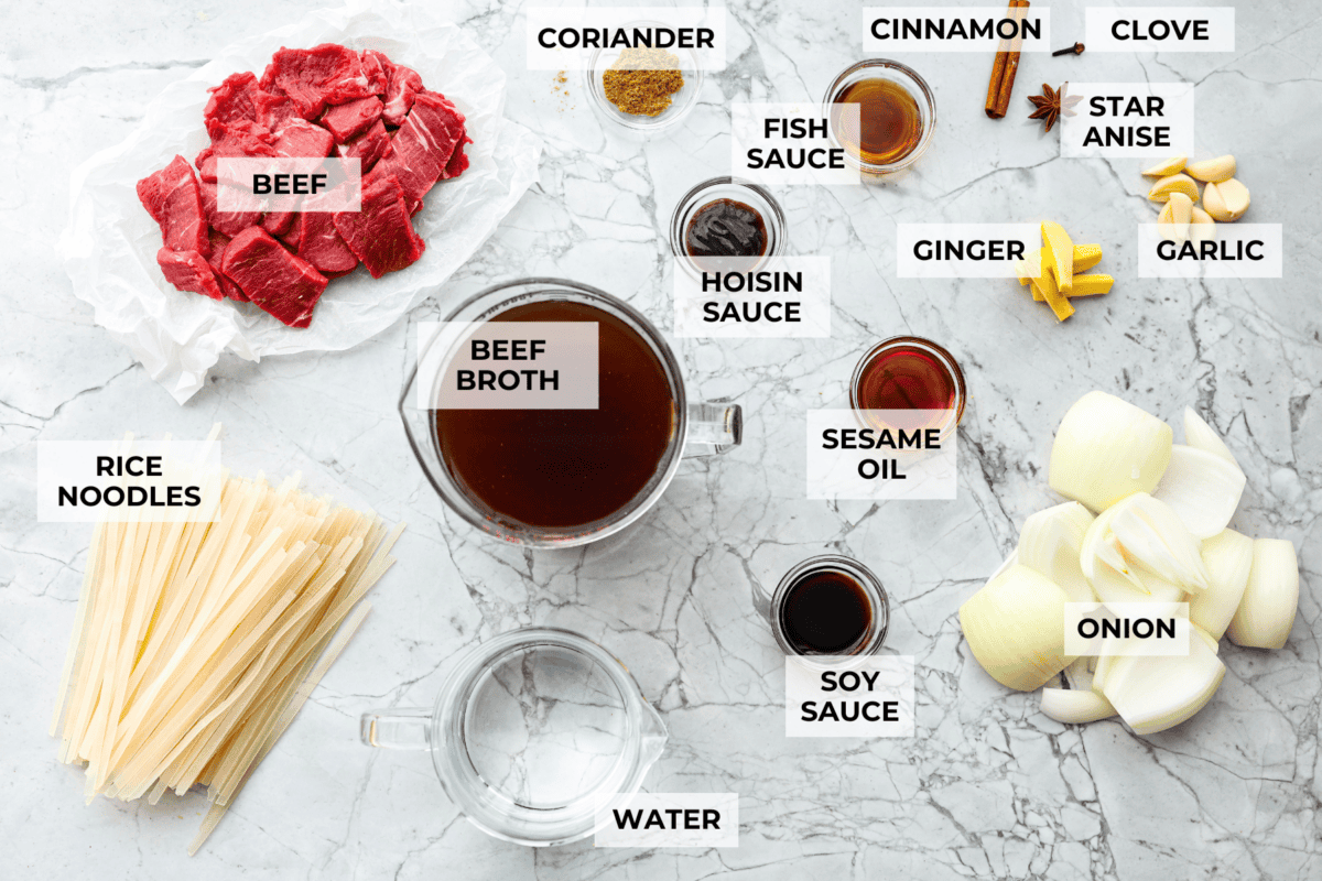 This simplified version of Vietnamese noodle soup brings the comforting flavors you love in Pho but with less effort. For a truly authentic experience, donโt miss out on this detailed recipe! Overhead shot of labeled Vietnamese noodle soup ingredients.