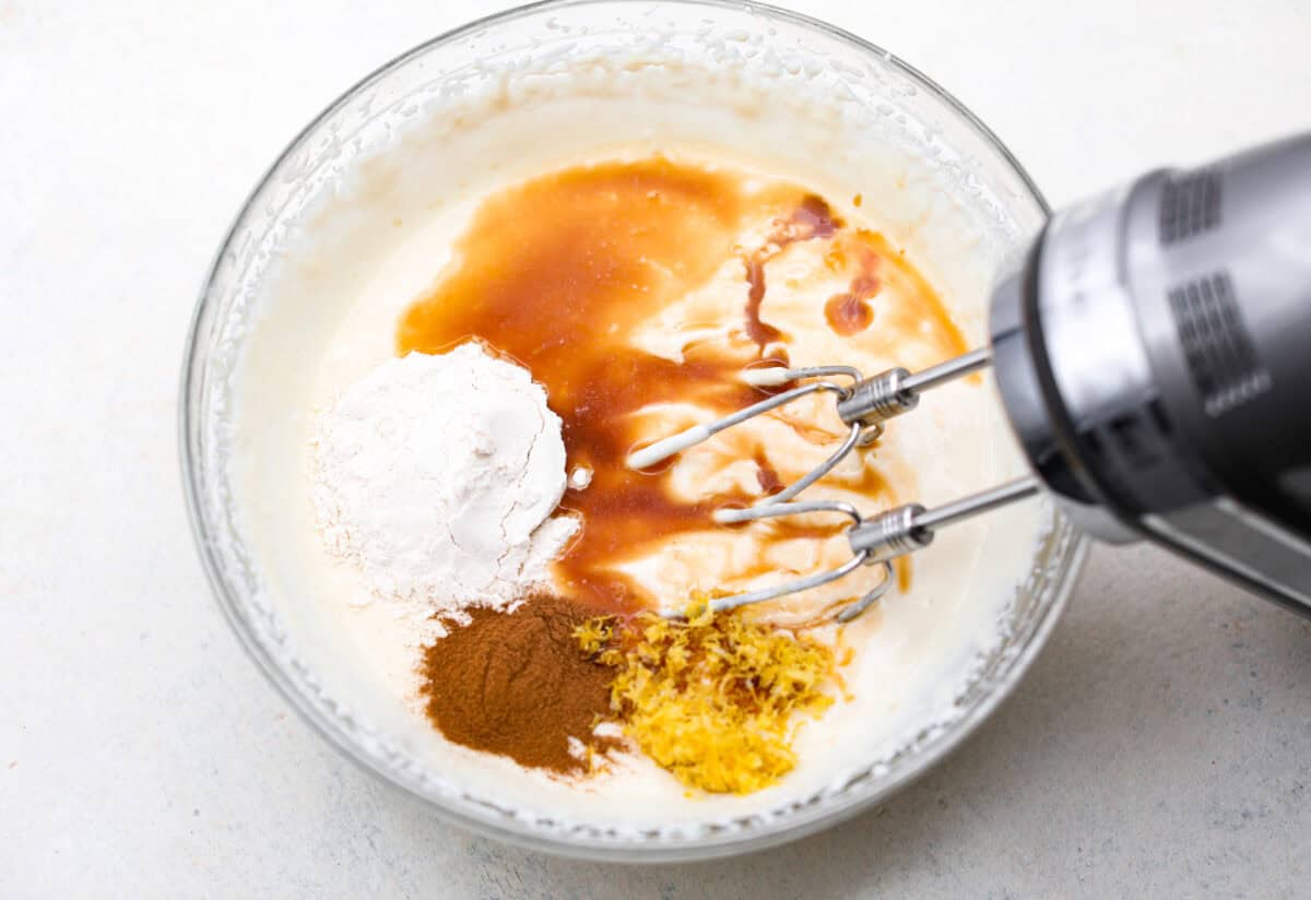 This creamy Ricotta Pie has a milky cinnamon flavor with a hint of lemon. The flavor is incredible, and it's surprisingly light for a cheese-based custard with its buttery shortbread crust. Overhead shot of the blended ricotta with vanilla, flour, cinnamon and lemon zest on top.