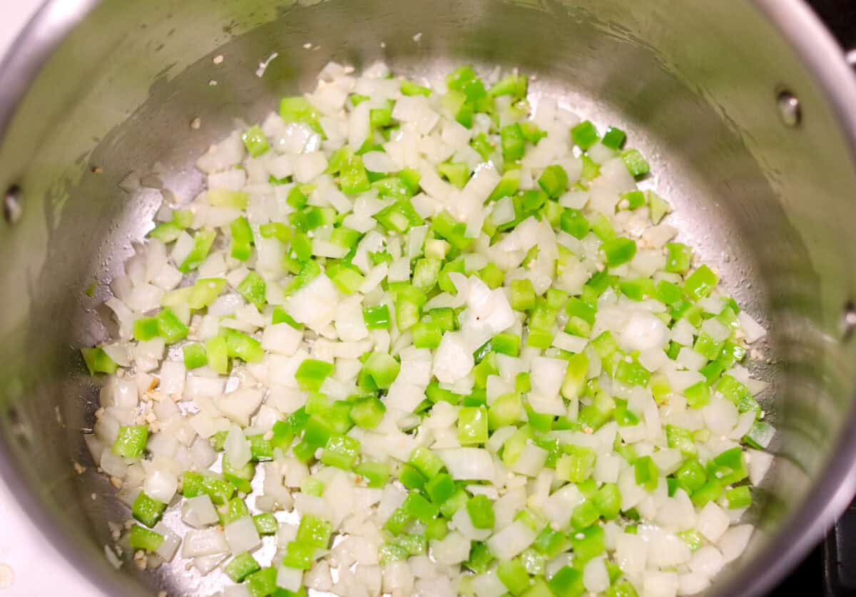 Turkey chili is such a comforting, satisfying meal! Packed with ground turkey, tender vegetables, hearty beans and a blend of bold spices, itโs filled with the most delicious flavor. Great for making ahead and feeding a crowd! Overhead shot of celery and onion and garlic sautรฉing in a pot.