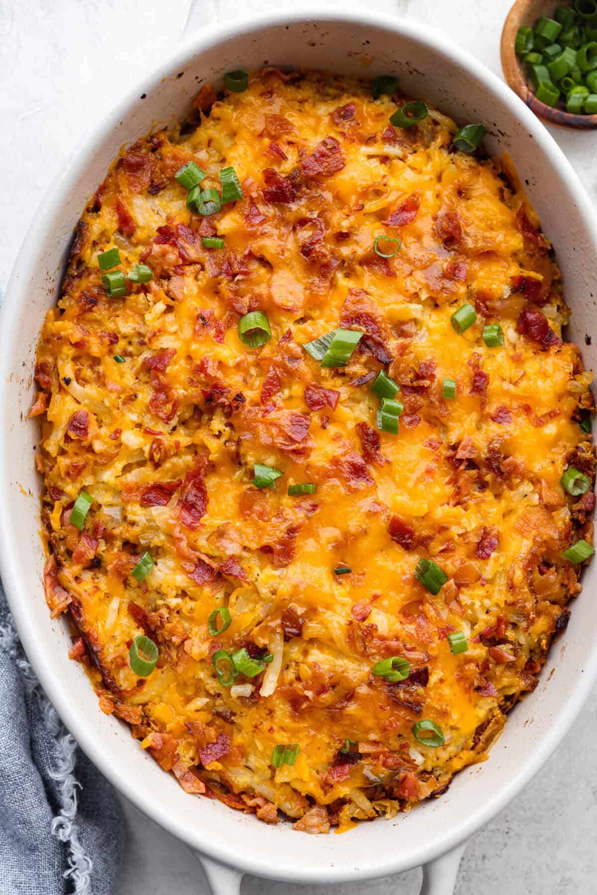 Kickstart your day with this hearty Amish Breakfast Casserole! It's loaded with crispy bacon, tender hash browns, and gooey melted cheese. This dish is a crowd-pleaser thatโs perfect for family breakfasts and holiday mornings! Overhead shot of amish breakfast casserole.