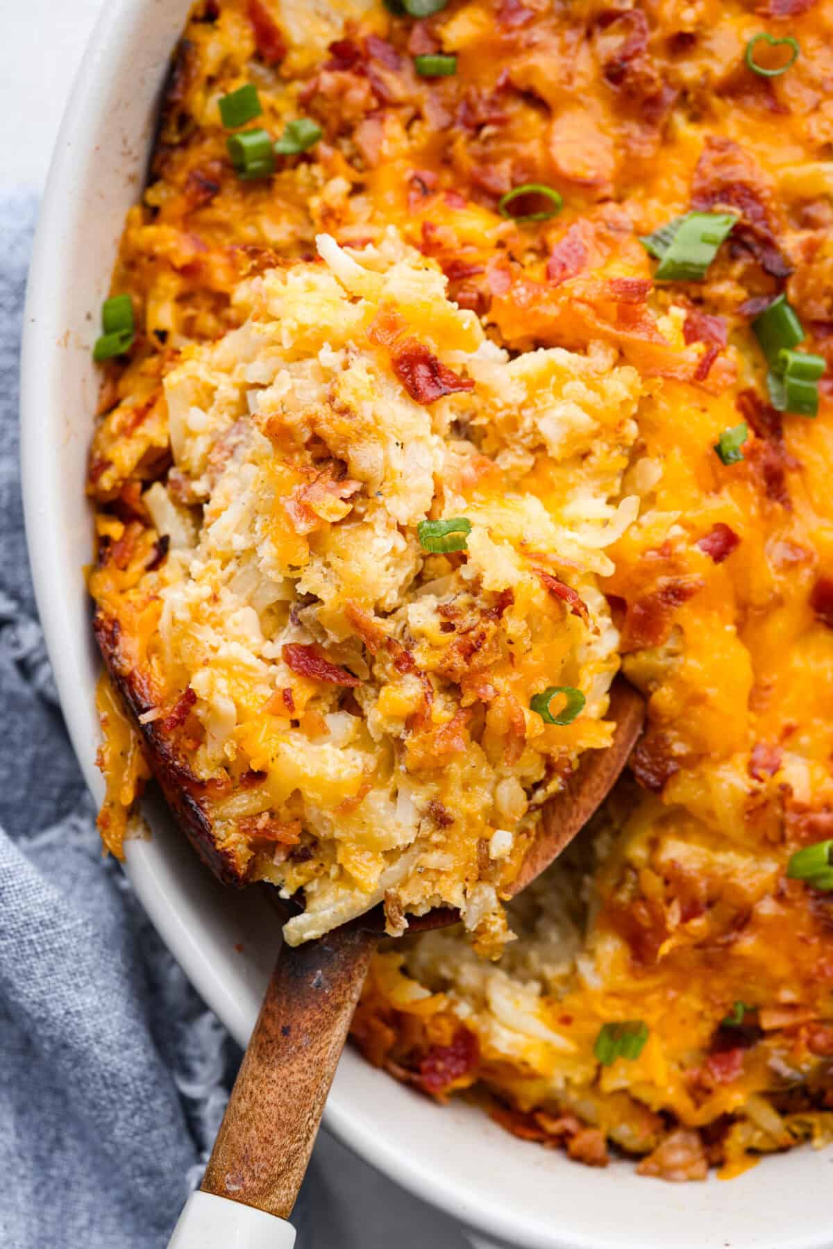 Kickstart your day with this hearty Amish Breakfast Casserole! It's loaded with crispy bacon, tender hash browns, and gooey melted cheese. This dish is a crowd-pleaser thatโs perfect for family breakfasts and holiday mornings! Close up shot of amish breakfast casserole.