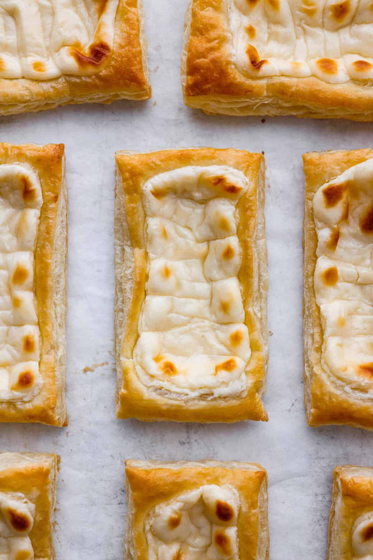 Craving the buttery goodness of a Starbucks cream cheese Danish? Now you can make it right at home! This easy copycat recipe uses flaky puff pastry and a sweet, creamy cheese filling for a treat that’s just as delicious, maybe even better! Close up shot of a Starbucks cream cheese danish from overhead.