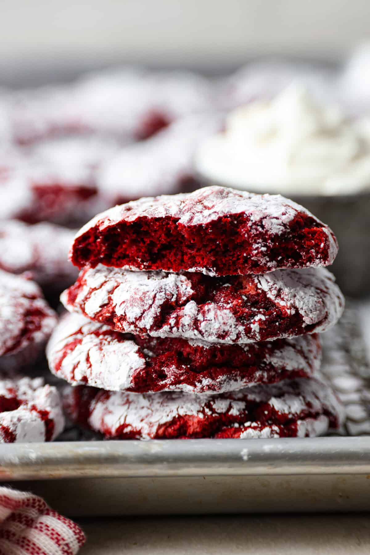 Gorgeous Cool Whip Cookies are made with just 4 simple ingredients! They bake up soft, fluffy, and bursting with flavor. Perfect for last-minute treats or when you’re craving something sweet without the fuss! Side shot of a stack of cool whip cookies on a baking sheet.