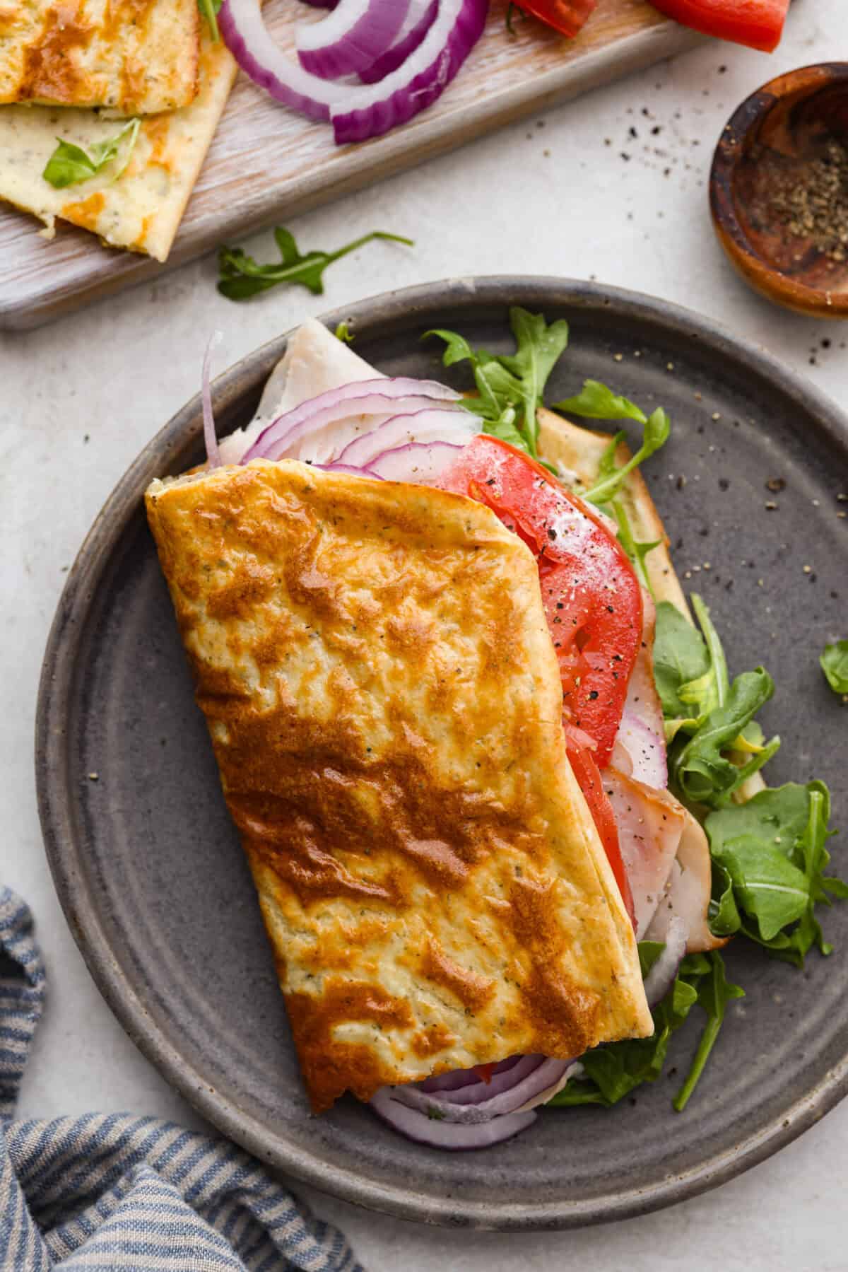 The viralย cottage cheese flatbreadย is a must try! Made with just cottage cheese, eggs and seasonings, itโs packed with almost 20 grams of protein. Use it to make delicious sandwiches or wraps for an easy lunch! Overhead shot of a sandwich made with cottage cheese flatbread.