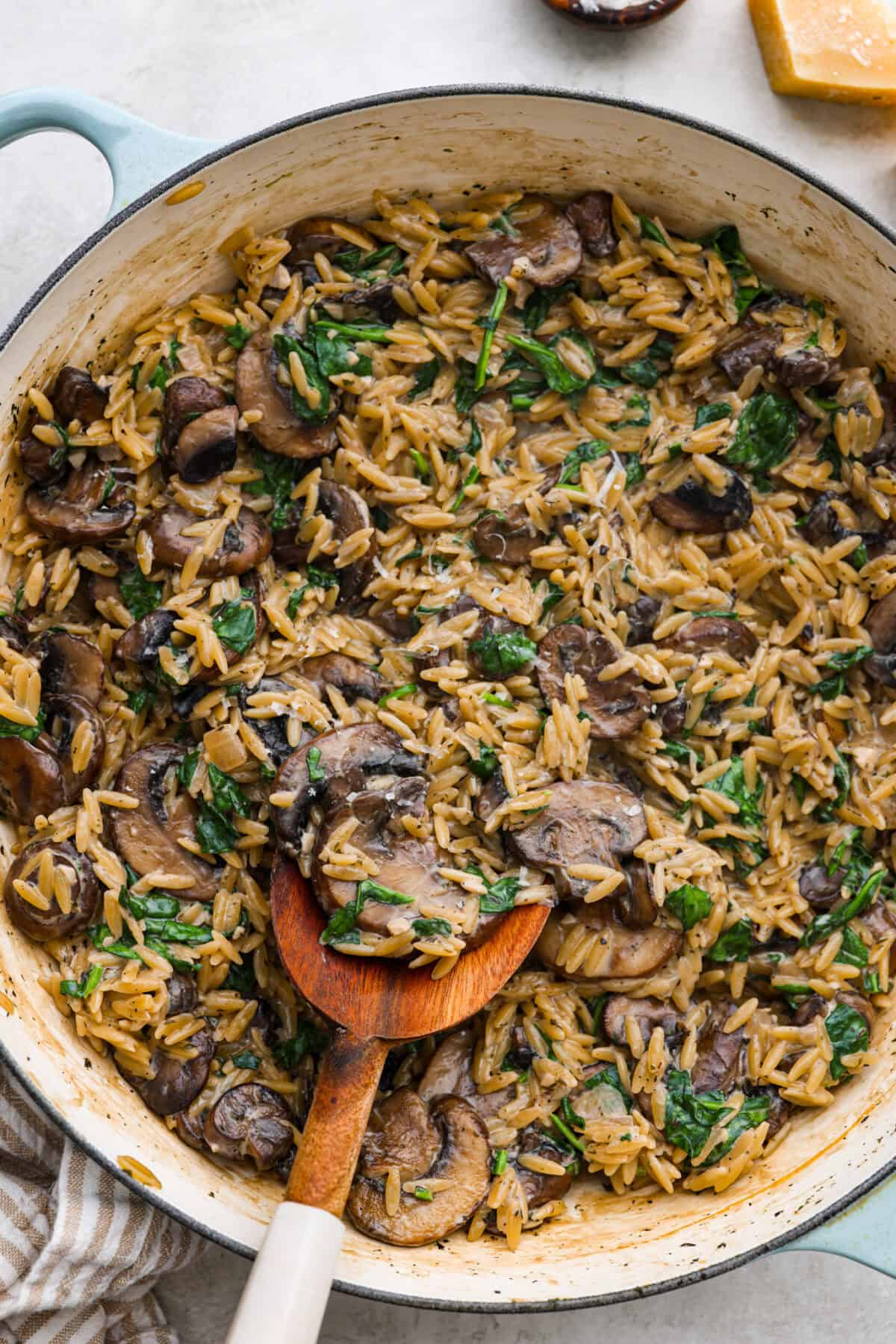 Mushroom orzo is a tasty, comforting side dish! It combines tender orzo pasta with rich, earthy mushrooms in a creamy sauce. It’s easy to make and sure to impress with satisfying texture and savory flavors. Overhead shot of mushroom orzo in a skillet.