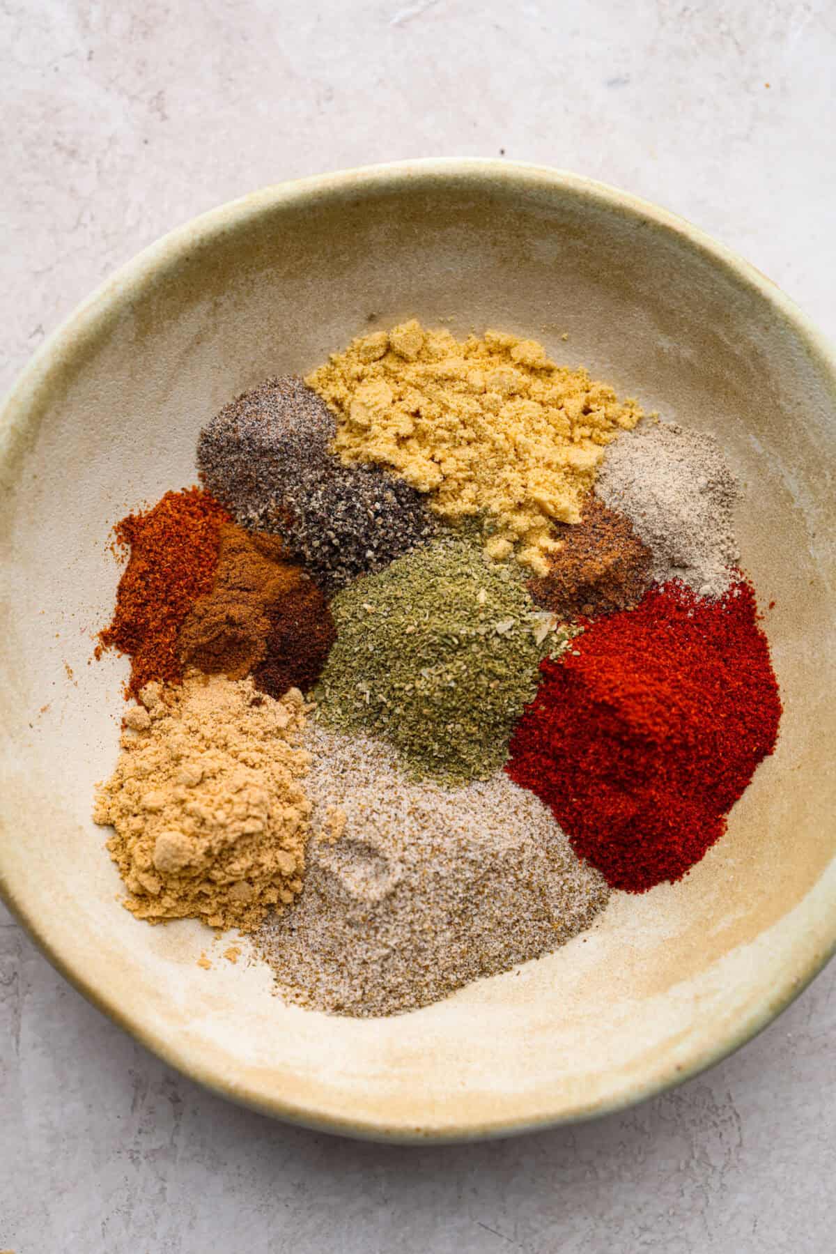 https://www.target.com/p/bodum-bistro-blade-grinder-stainless-steel/-/A-54612773#lnk=sametab Overhead shot of all of the homemade old bay seasoning ingredients divided up on a plate.