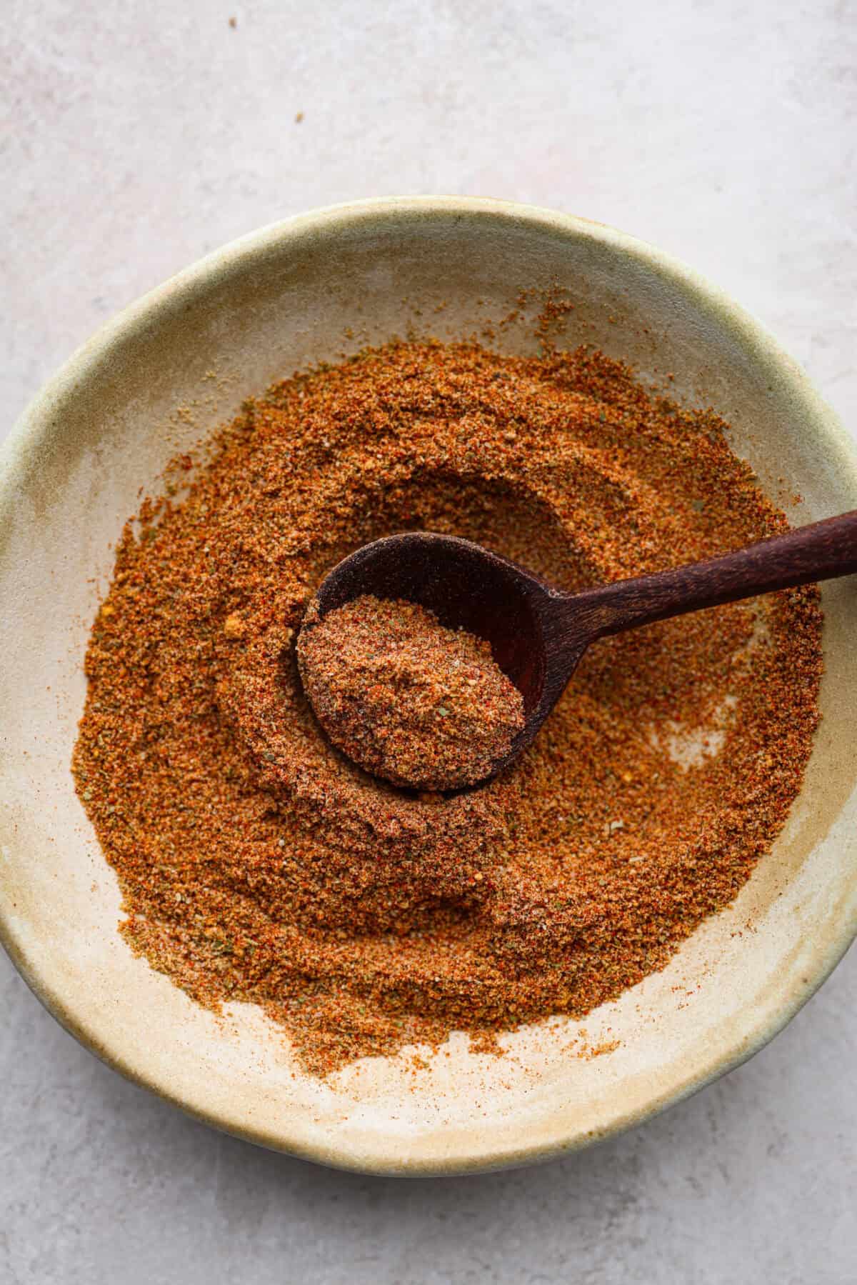 https://www.target.com/p/bodum-bistro-blade-grinder-stainless-steel/-/A-54612773#lnk=sametab Overhead shot of homemade old bay seasoning mixed together on a plate with a wooden spoon.