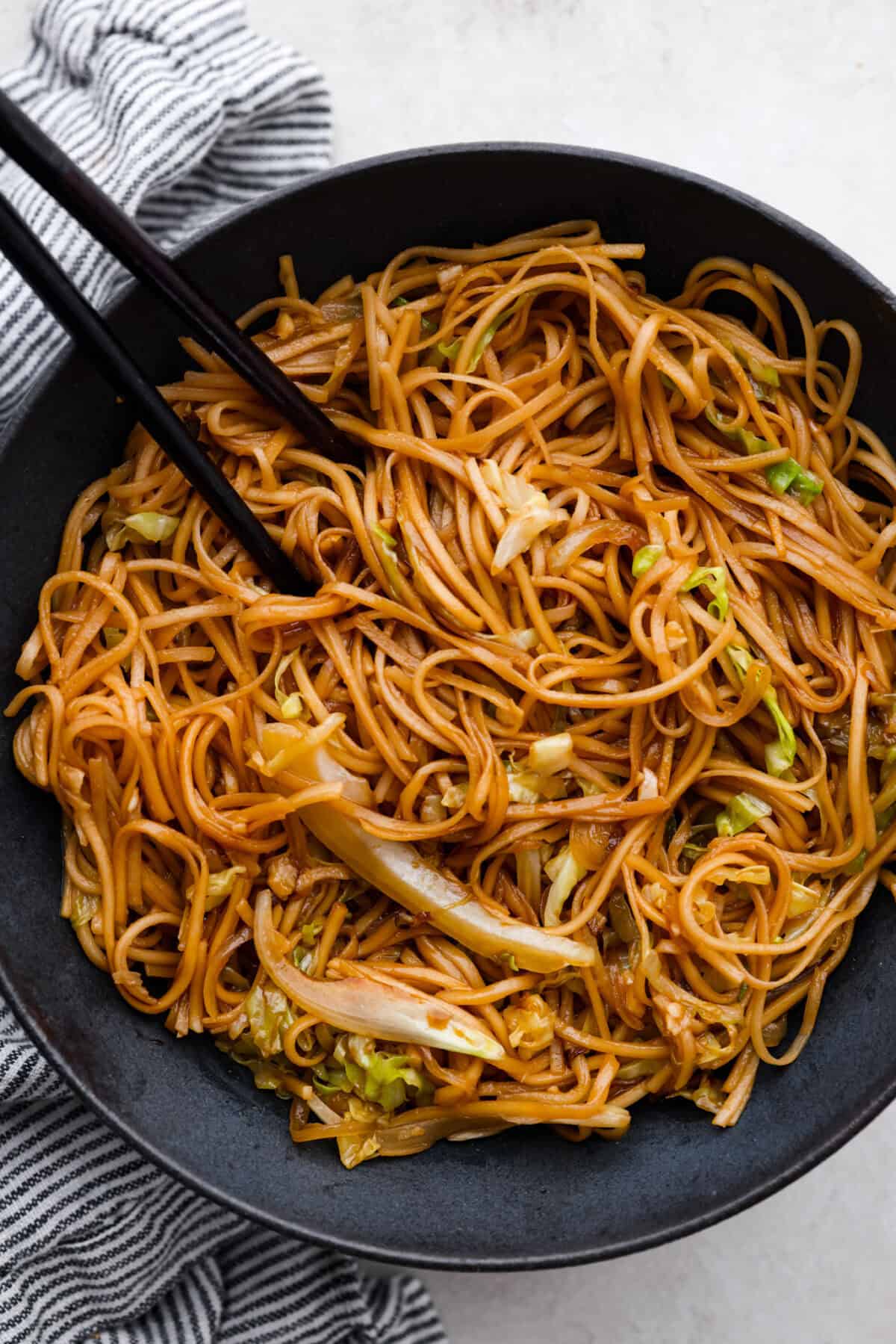 Add outbound links by finding items you can link through Target links. And add them the same way you would add an internal link by pasting the link into the bar. Overhead shot of a bowl of Panda Express low mein with chopsticks.