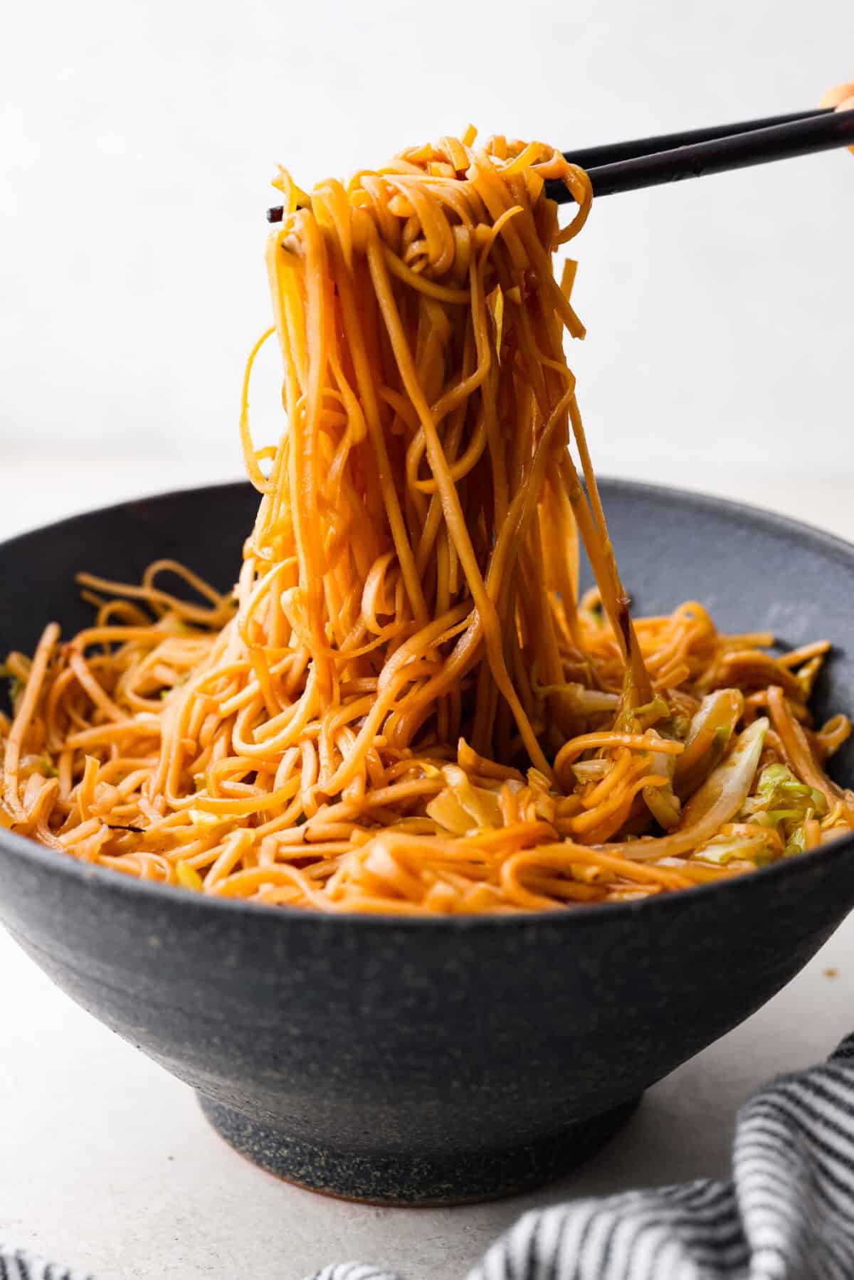 Add outbound links by finding items you can link through Target links. And add them the same way you would add an internal link by pasting the link into the bar. Side shot of chopsticks pulling up a large bite of panda express low mein noodles from a bowl.