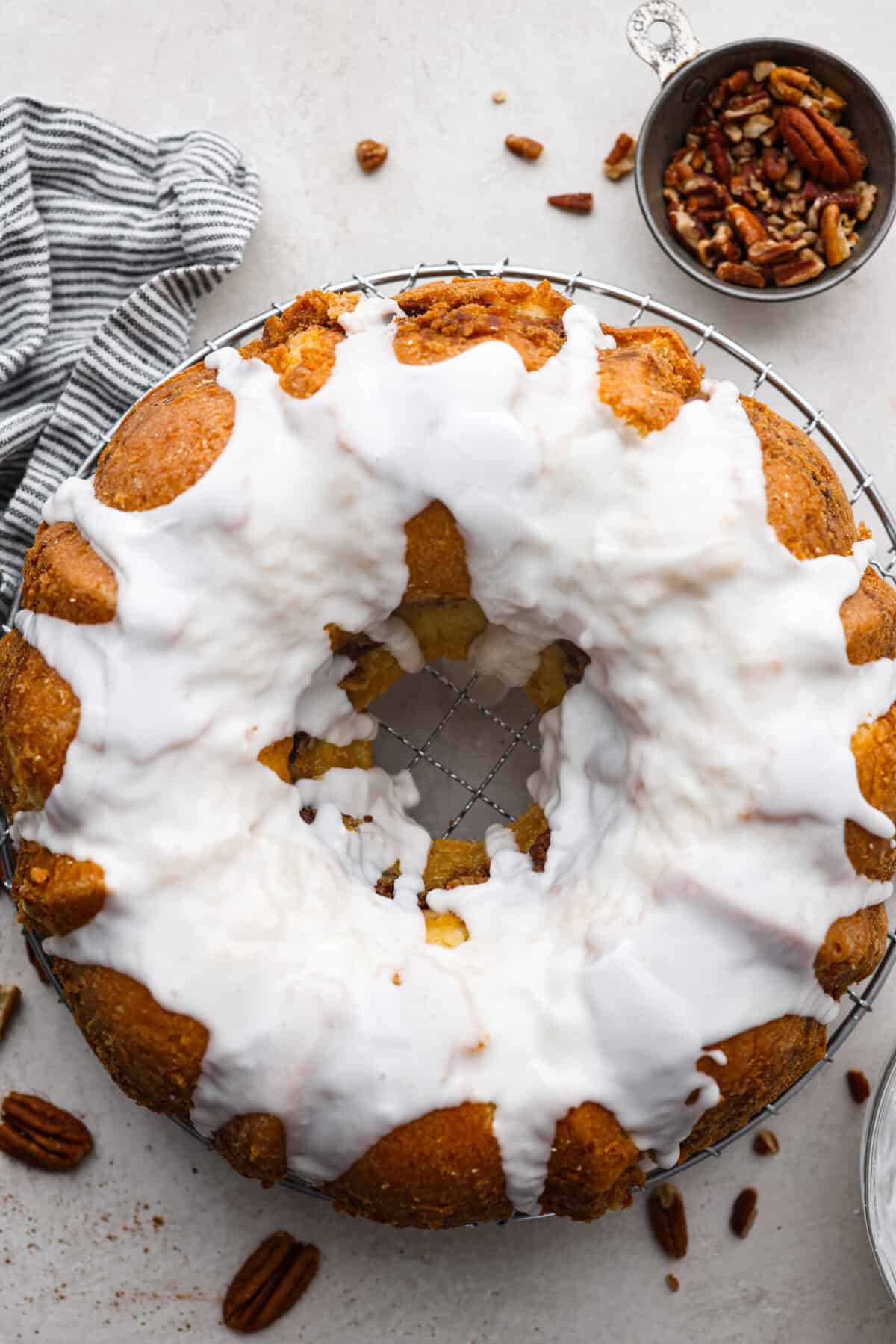 This Sock It to Me Cake is a moist, buttery Southern bundt cake with a delicious cinnamon-sugar pecan layer swirled through the middle. It became popular because of Duncan Hines in the 1960s and 1970s, and you'll understand why once you try it! Overhead shot of sock it to me cake on a wire cooling rack.
